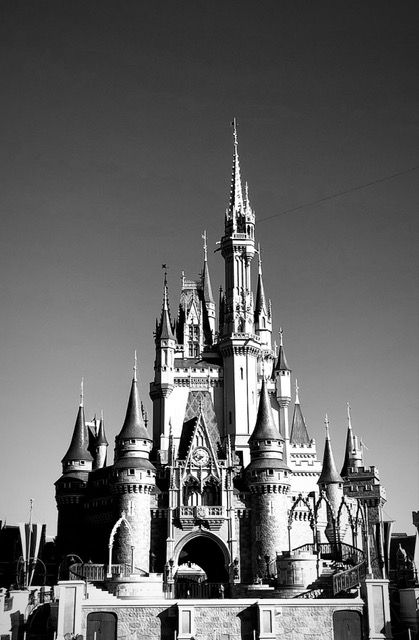 A dramatic black and white photo of Cinderella Castle at Walt Disney World against a clear sky.