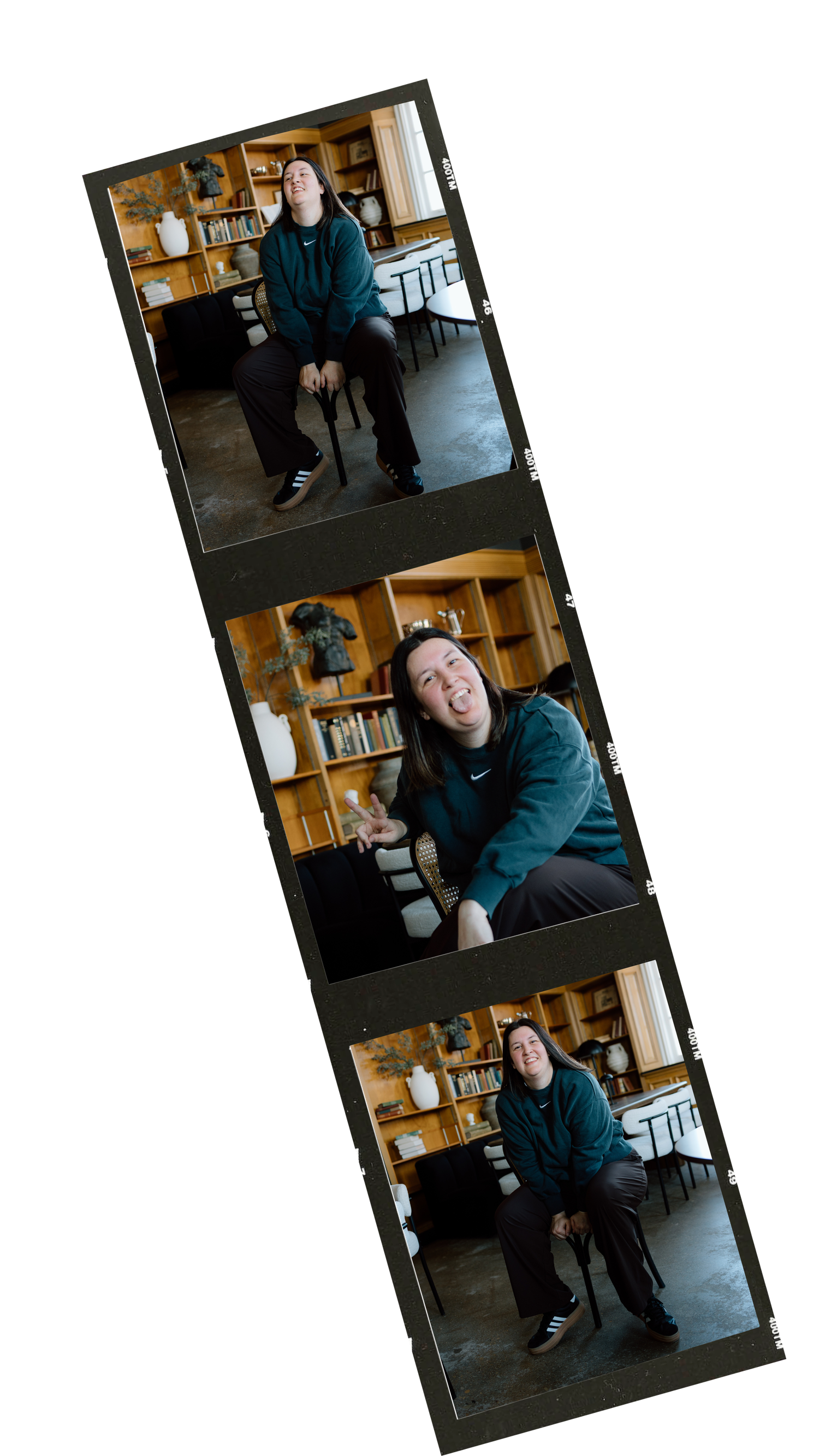 A film contact sheet strip showing three frames of a person in a teal jacket posing in a cozy library setting.