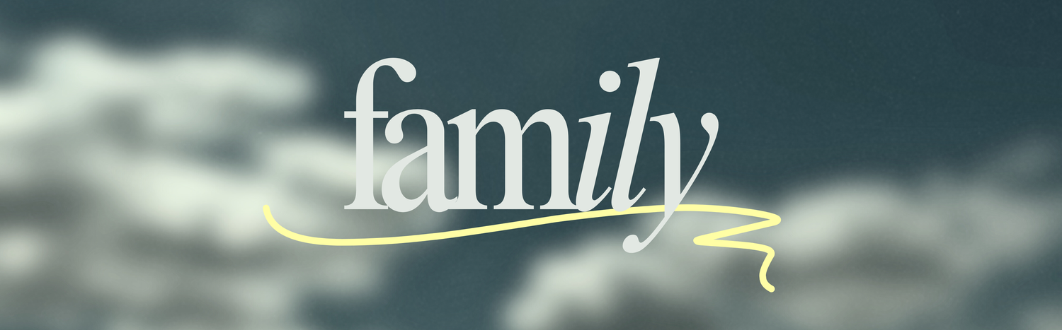 Soft focus family text logo with yellow swirl on cloudy blue-gray background.