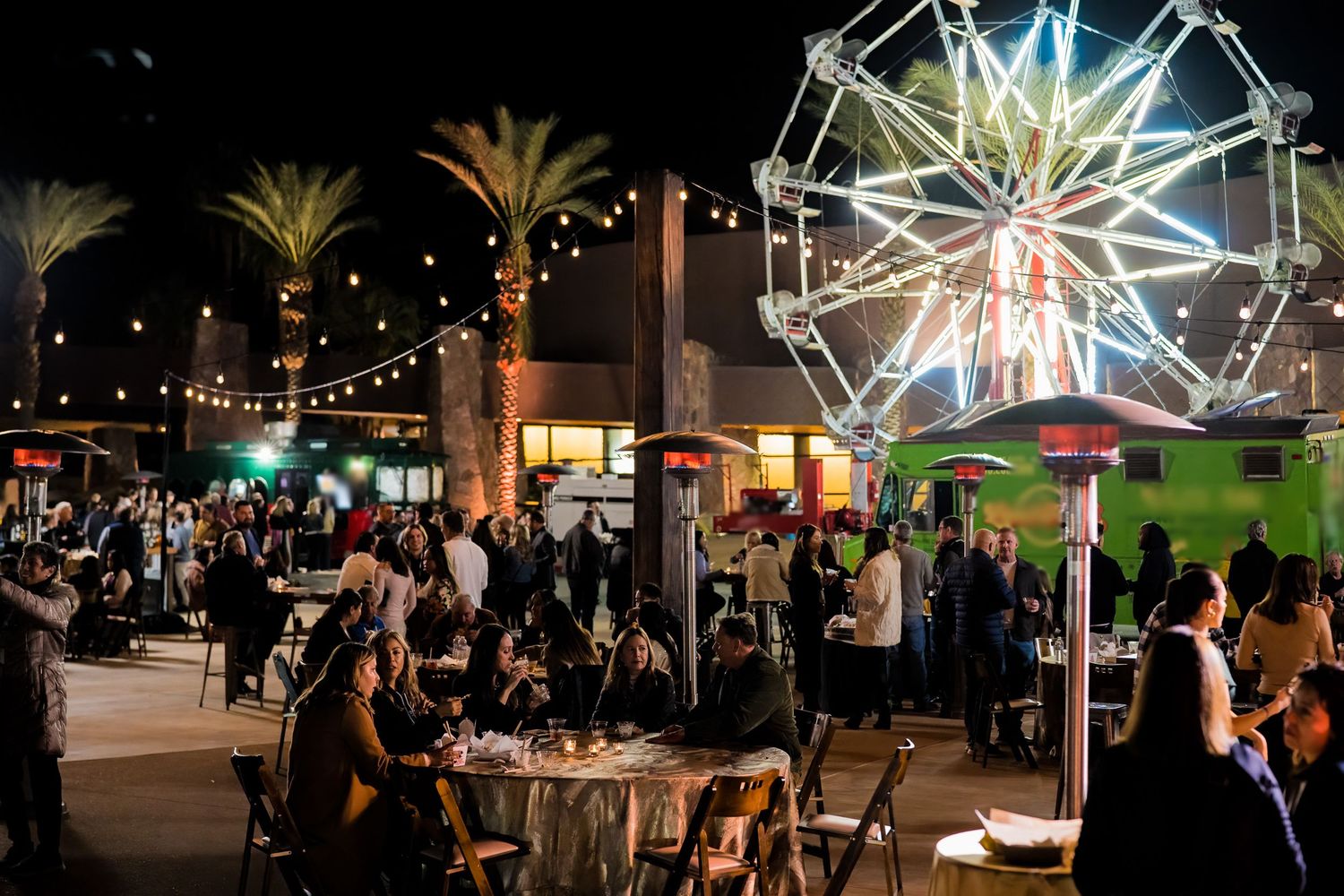 Mountain Productions image of a large outdoor carnival like corporate event, with food trucks and a ferris wheel.