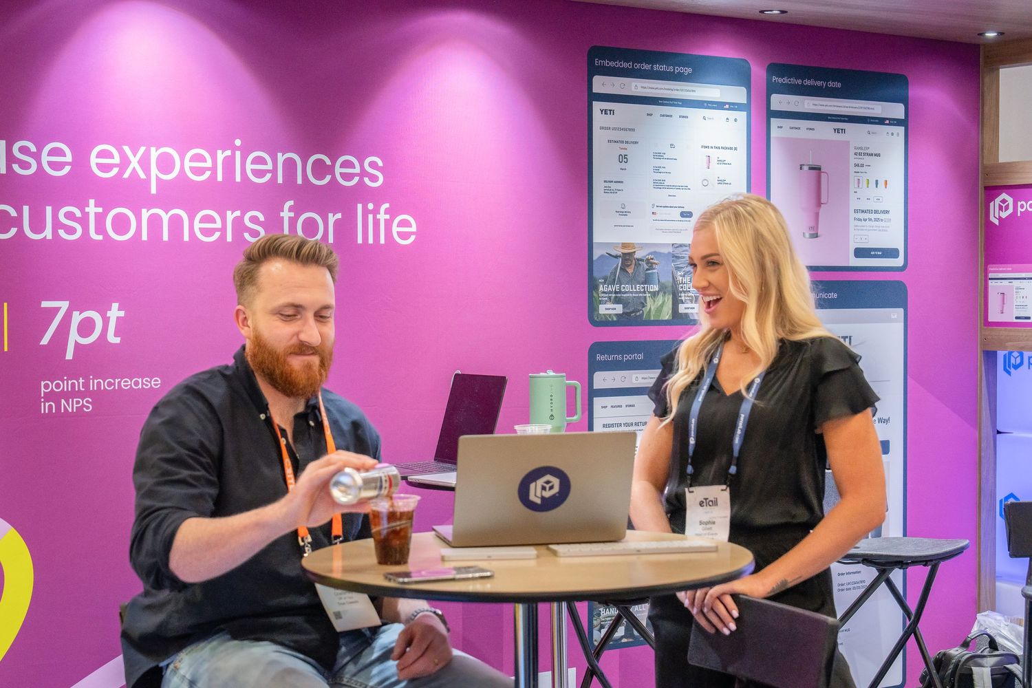 Mountain Productions image of two colleagues interacting at their experiential booth at a trade show.