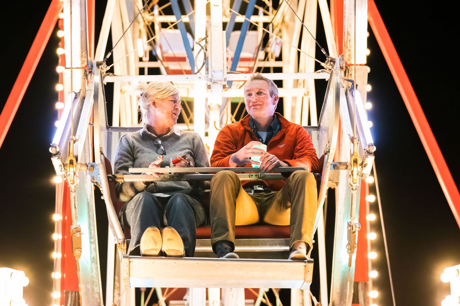 Mountain Productions image of two guests laughing and smiling as they ride the ferris wheel.