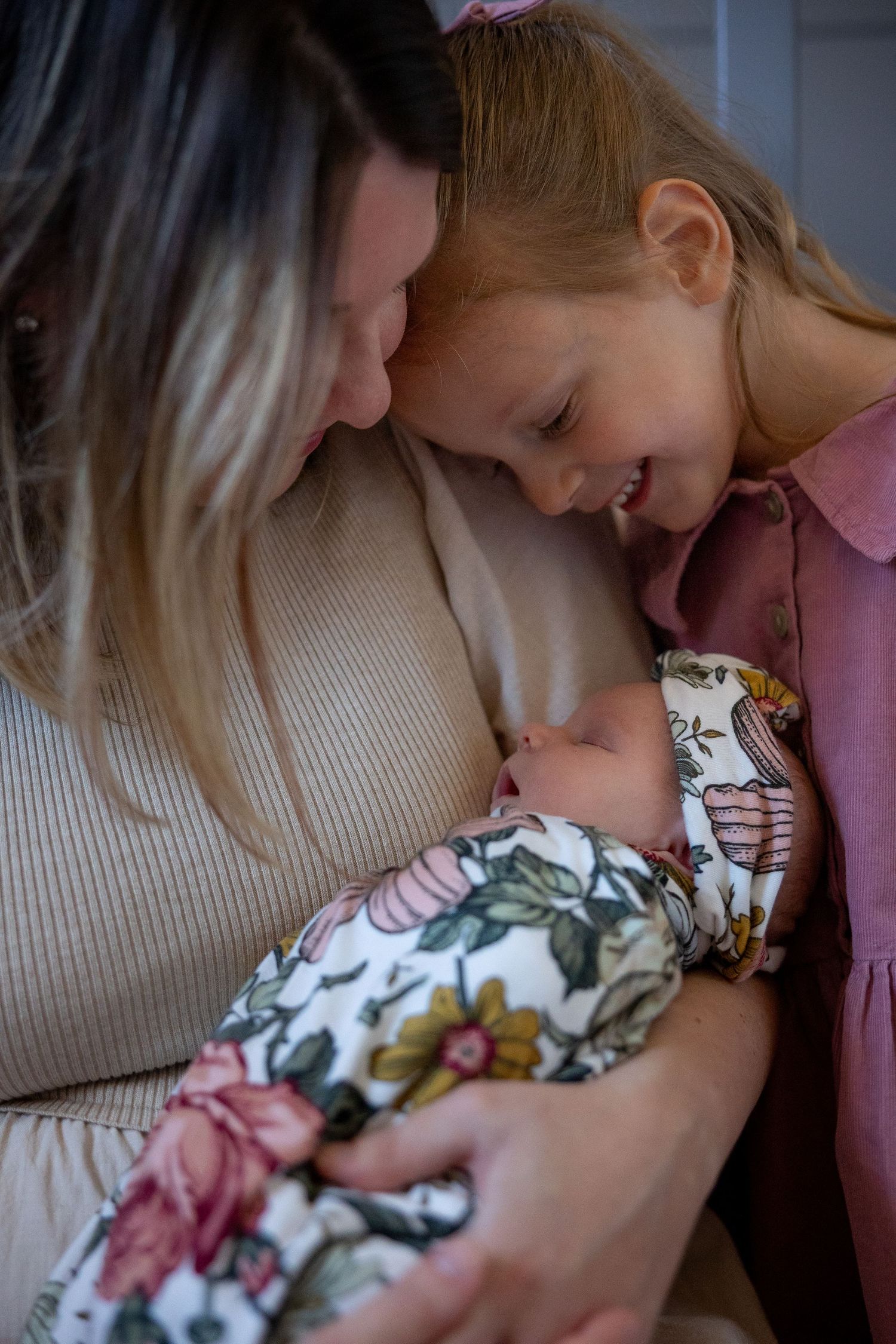 Mother and toddler cradling newborn baby during lifestyle newborn session in Mercer County, New Jersey, by Rego Photography