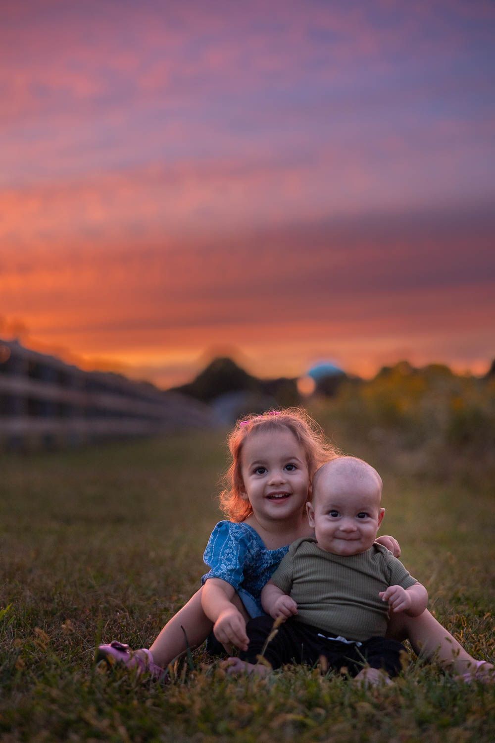 Siblings posing during golden hour sunset family photo session at Swedes Run in Moorestown, NJ