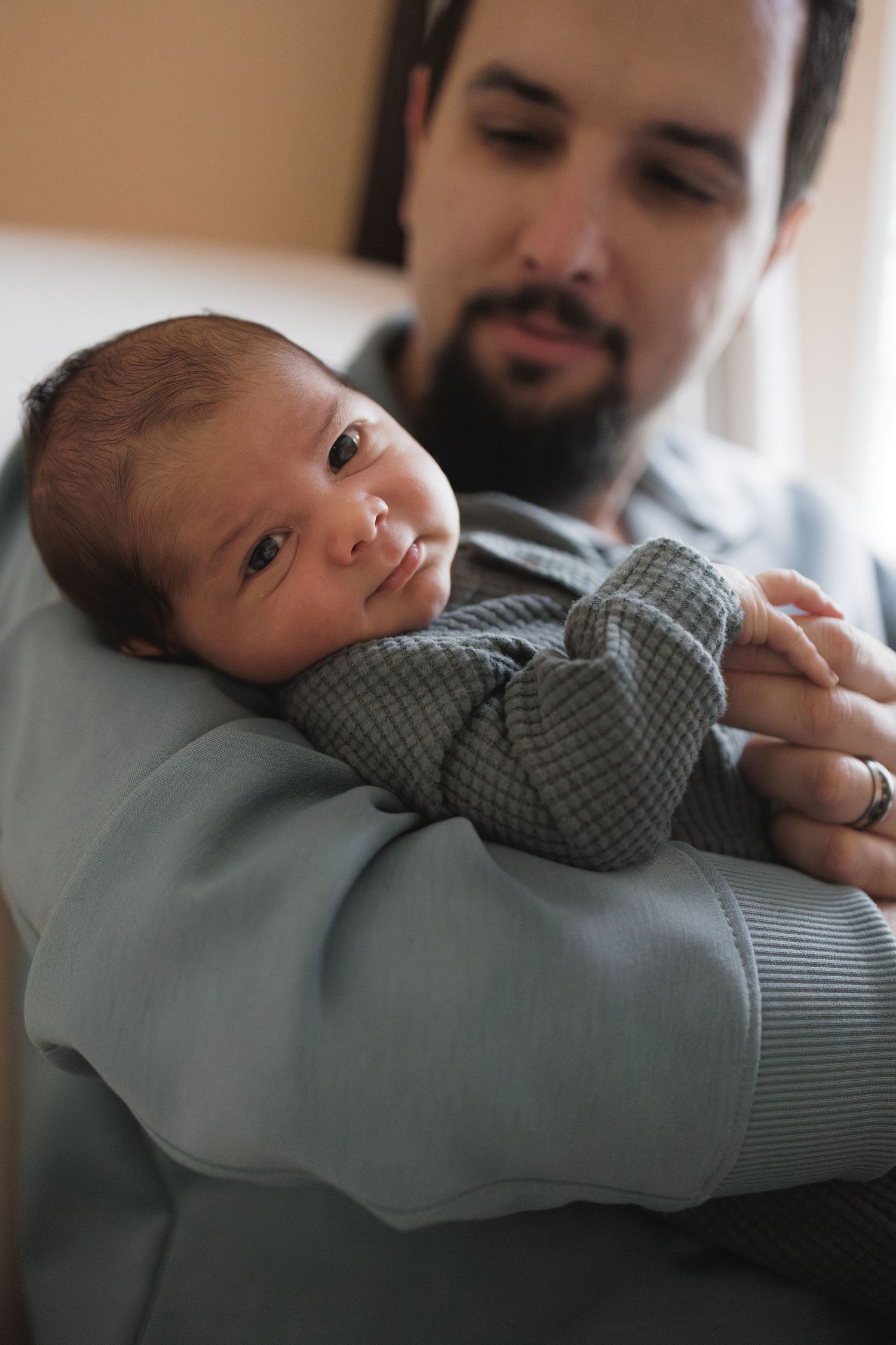 Newborn photo with father during lifestyle newborn photo session in Collingswood, New Jersey, by Rego Photography