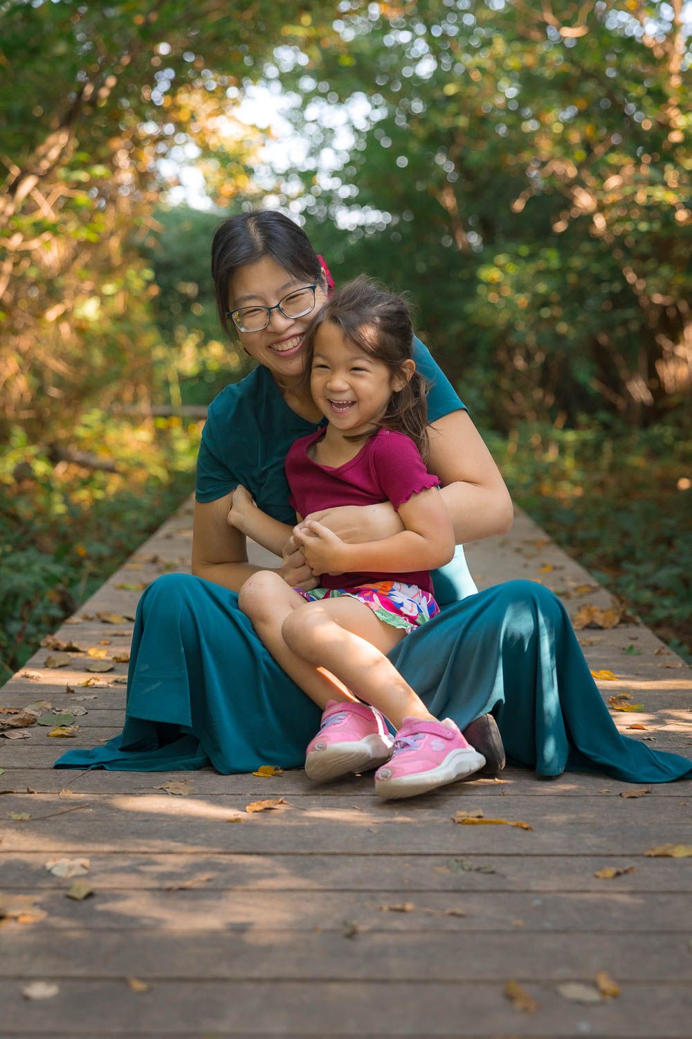 Mother and daughter hugging on boardwalk pathway at Boundary Creek Natural Resource Area in Moorestown, NJ