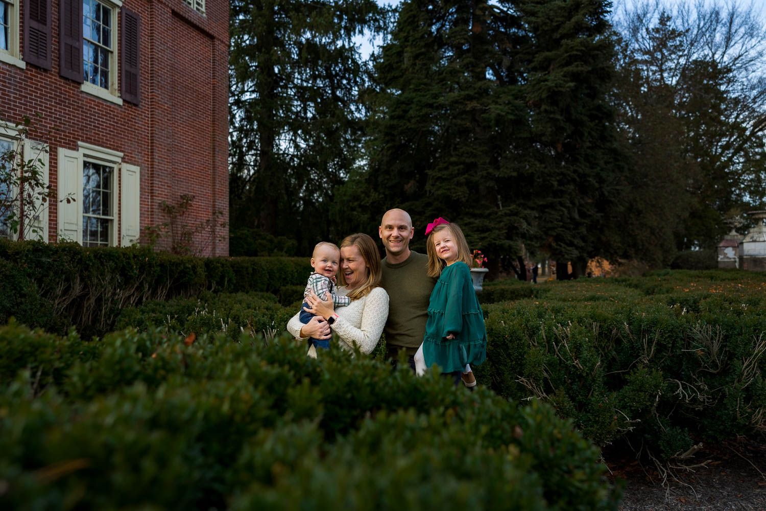 Family embracing during fall family photo session at Historic Smithville Park in Burlington County, NJ