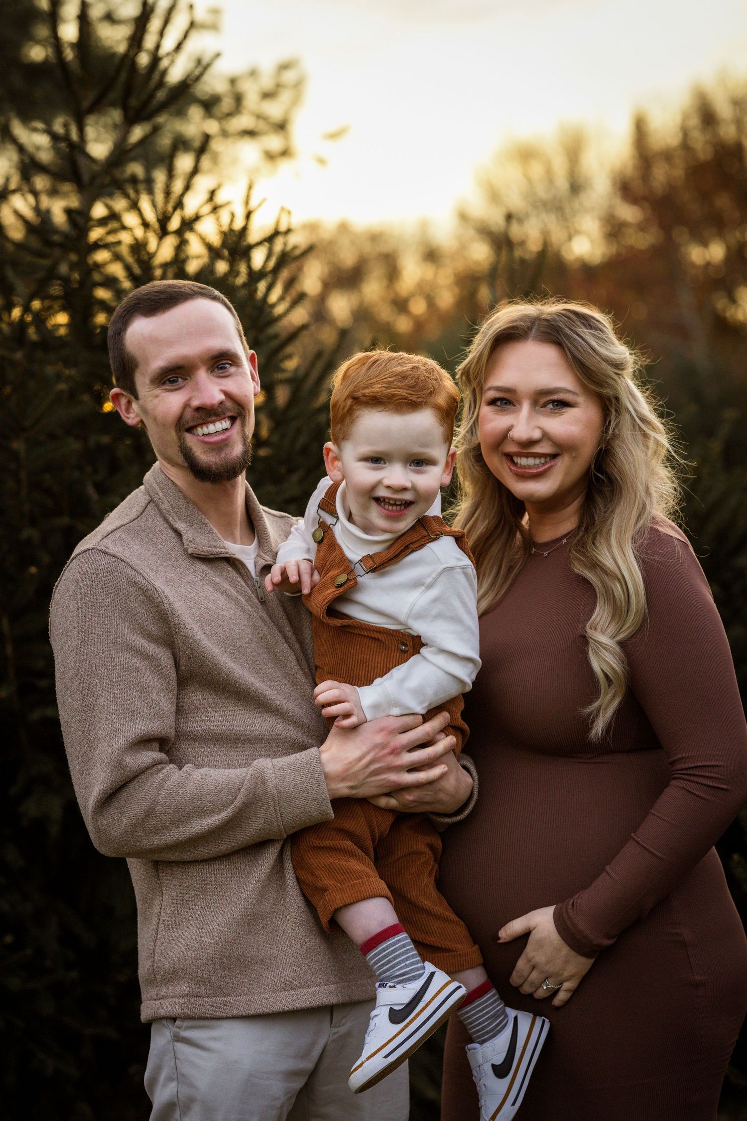 Family portrait during family photo session during golden hour at a Christmas Tree Farm in Burlington County, NJ, by Rego Photography