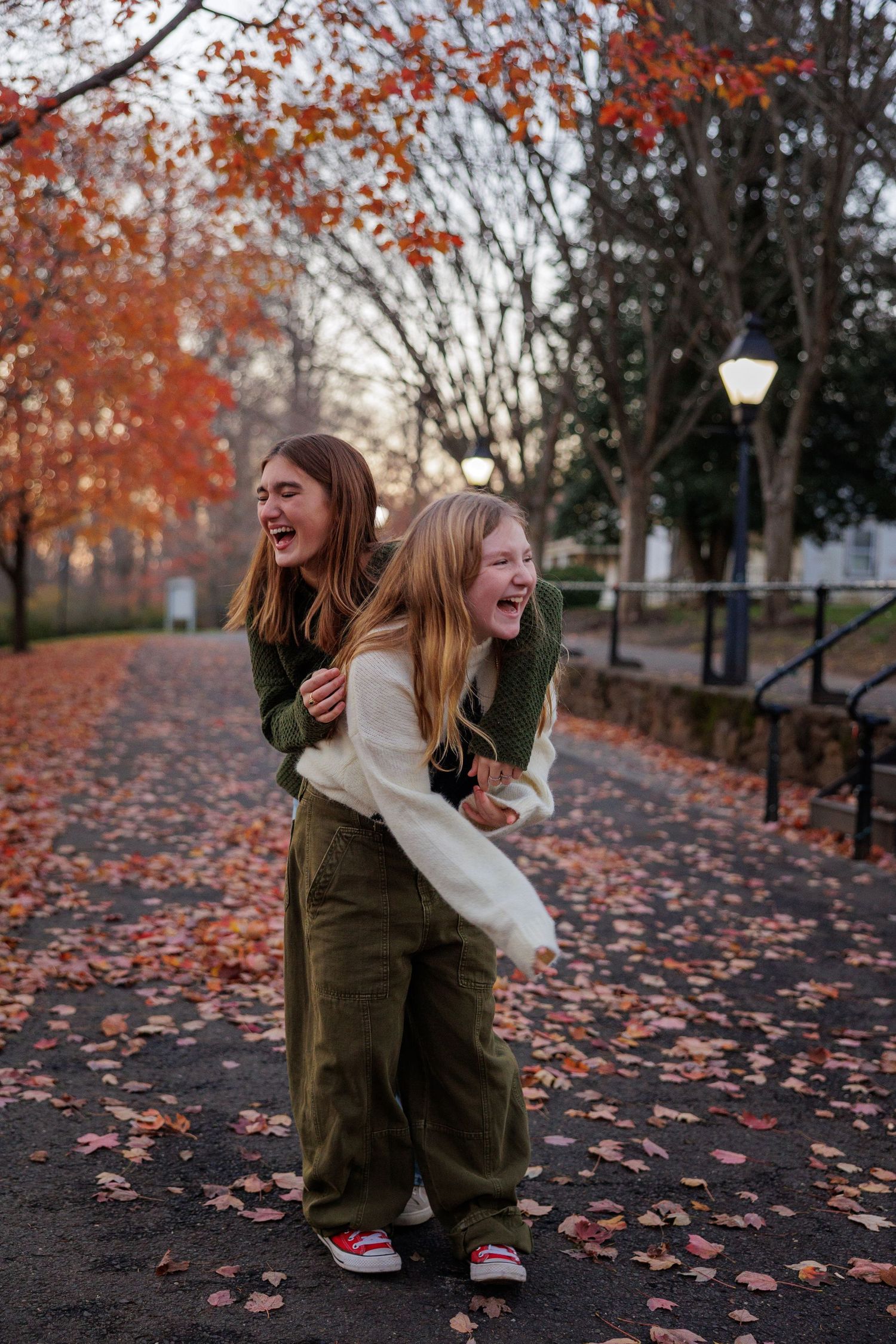 Siblings captured laughing during family photo session at Smithville Park, Burlington County, New Jersey, by Rego Photography