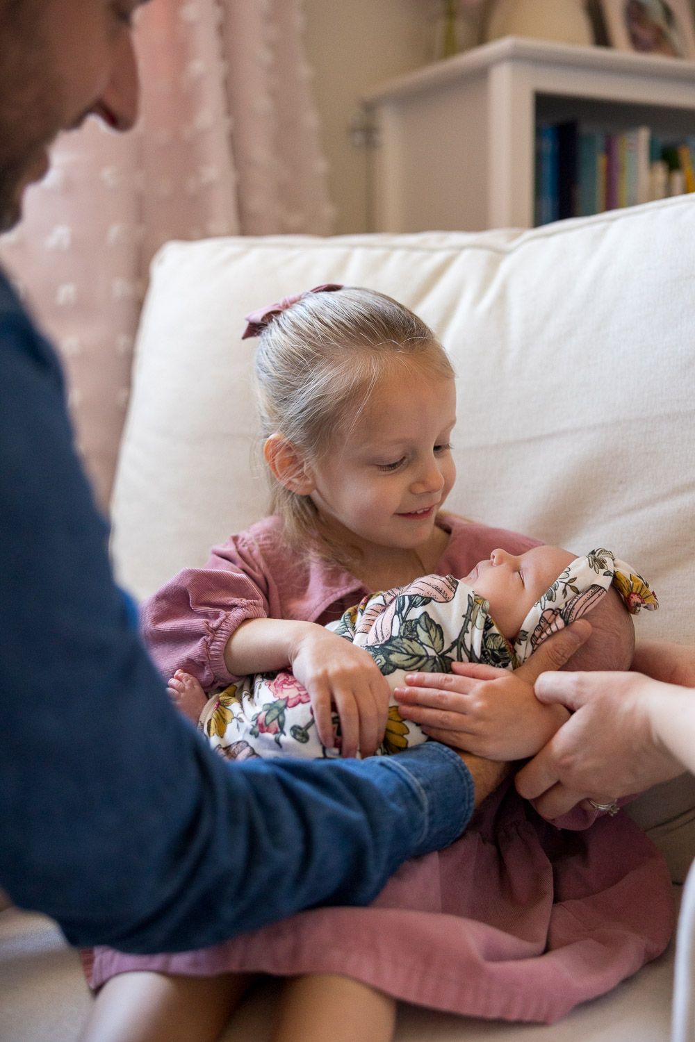 Older sibling holding baby during in-home lifestyle newborn session in Burlington County / South Jersey