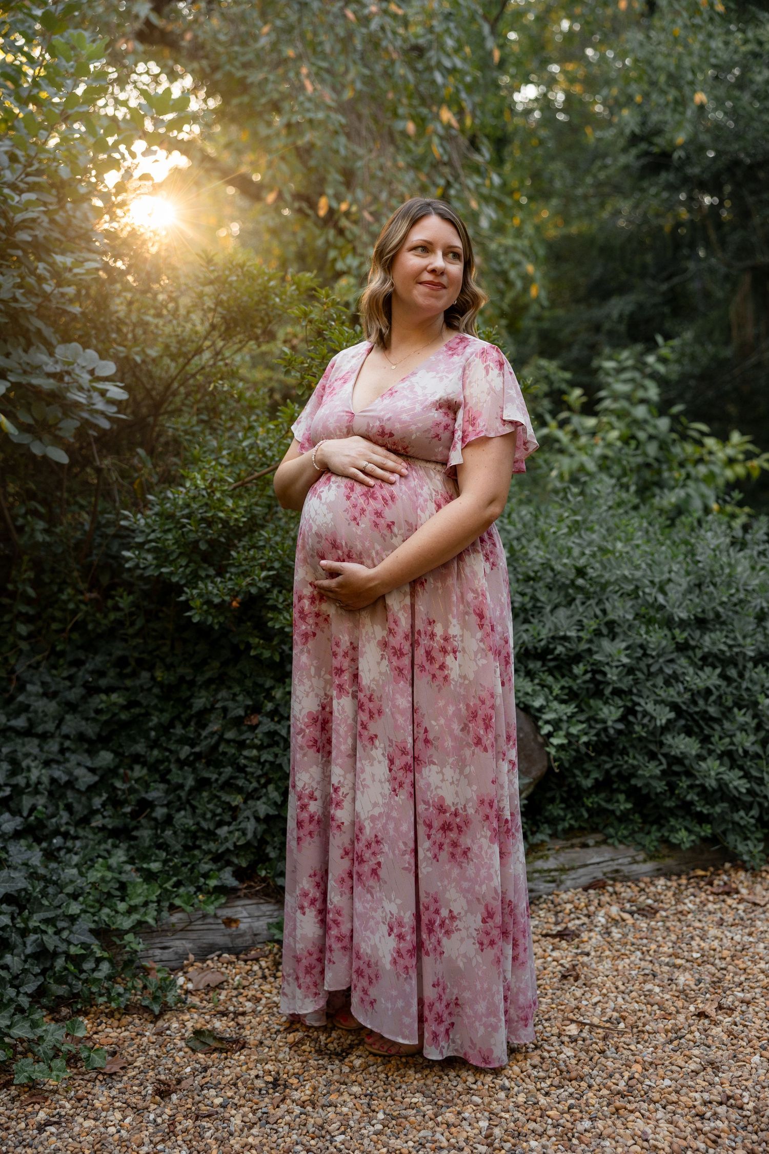 Expectant mother cradling bump in maternity session at Sayen Gardens in Hamilton, New Jersey, by Rego Photography, newborn photographer