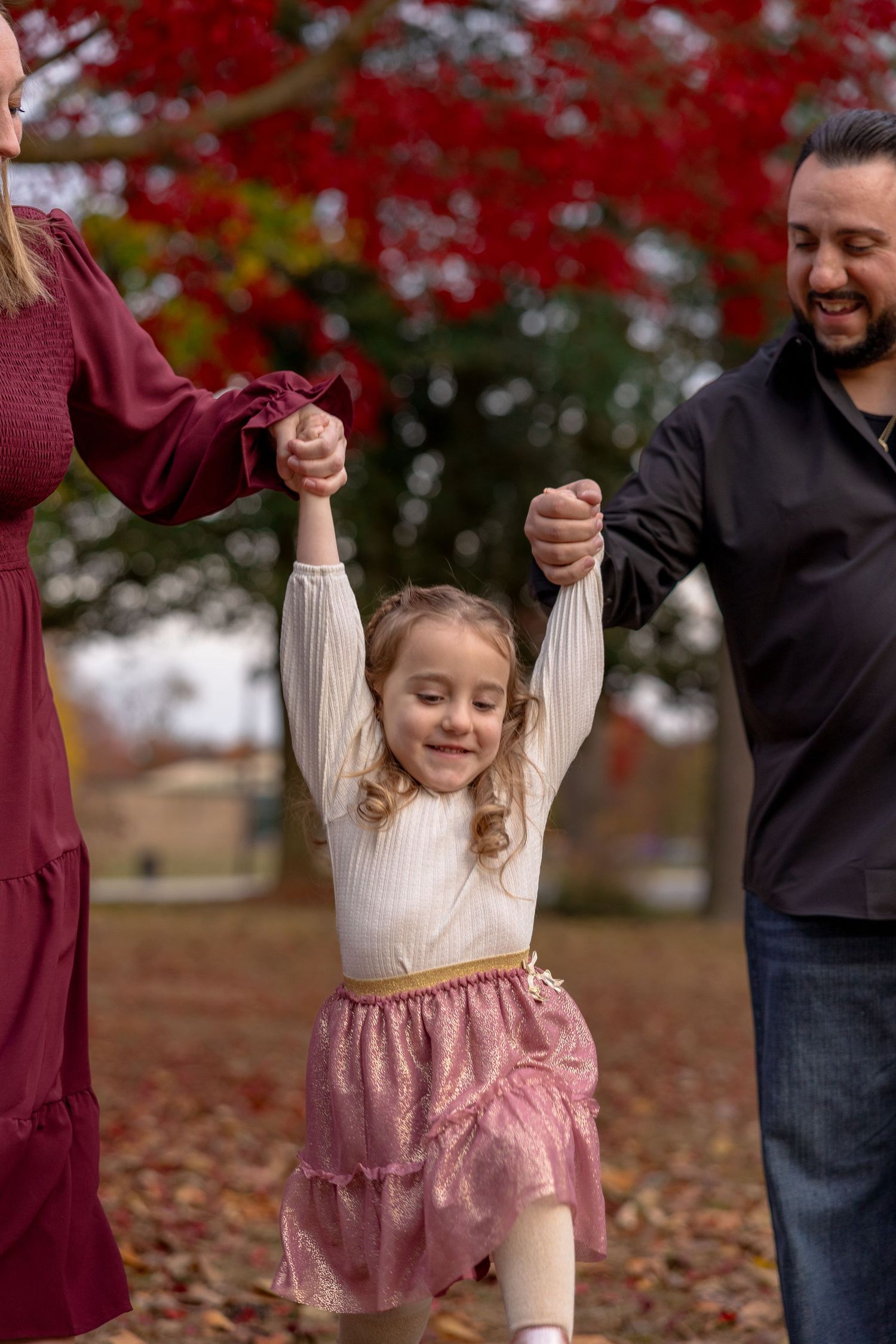 Toddler holding hands with parents in family photo session at Croft Farm, Cherry Hill, NJ by Rego Photography, family photographer