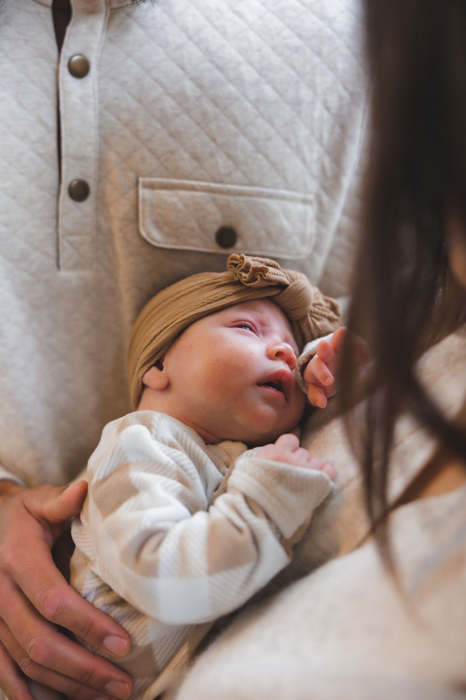 Sleepy baby held by parents in lifestyle newborn session in Mercer County, New Jersey, by Rego Photography, newborn photographer