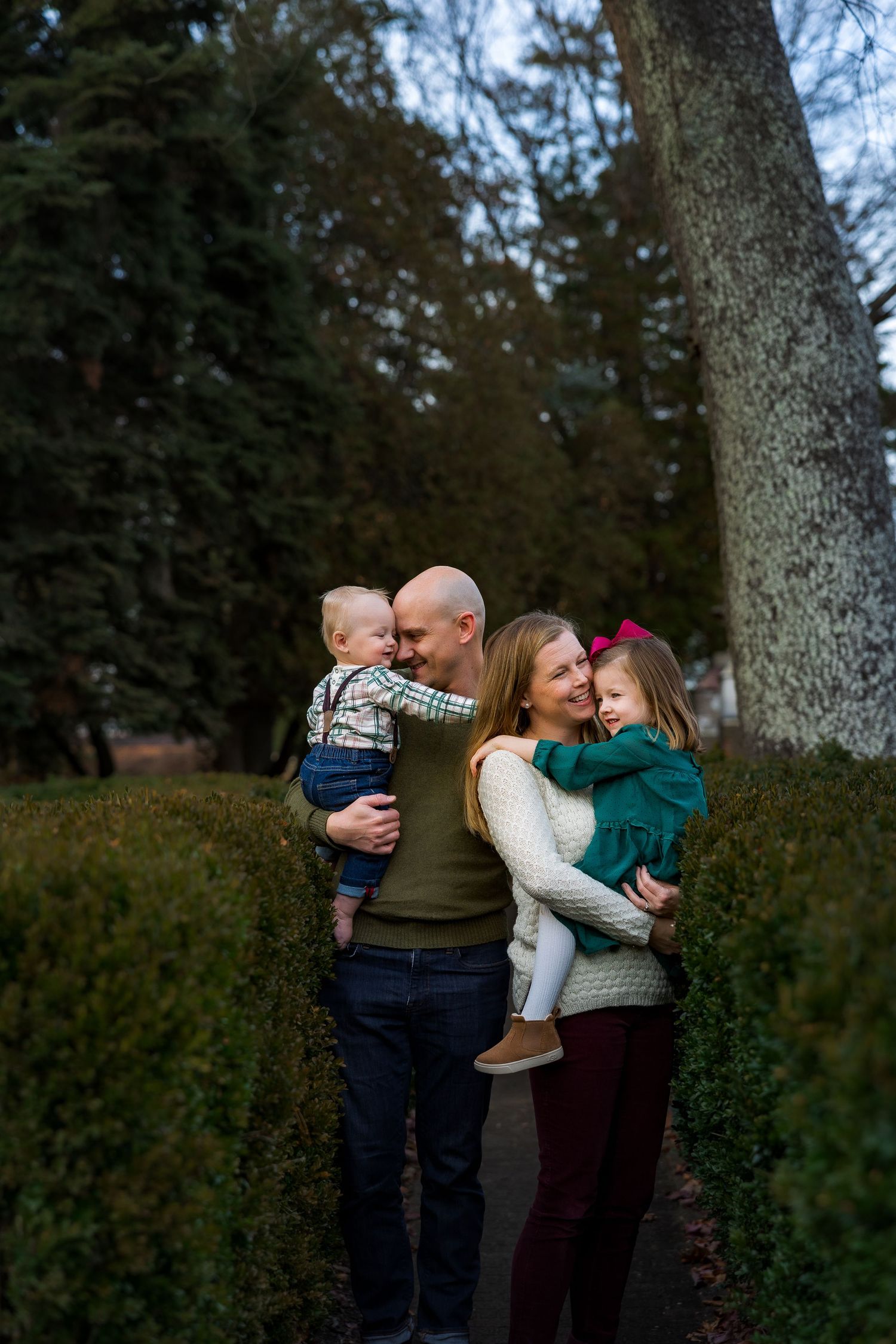 Family with small children cuddling during family session at Smithville Park, Burlington County, NJ, by Rego Photography