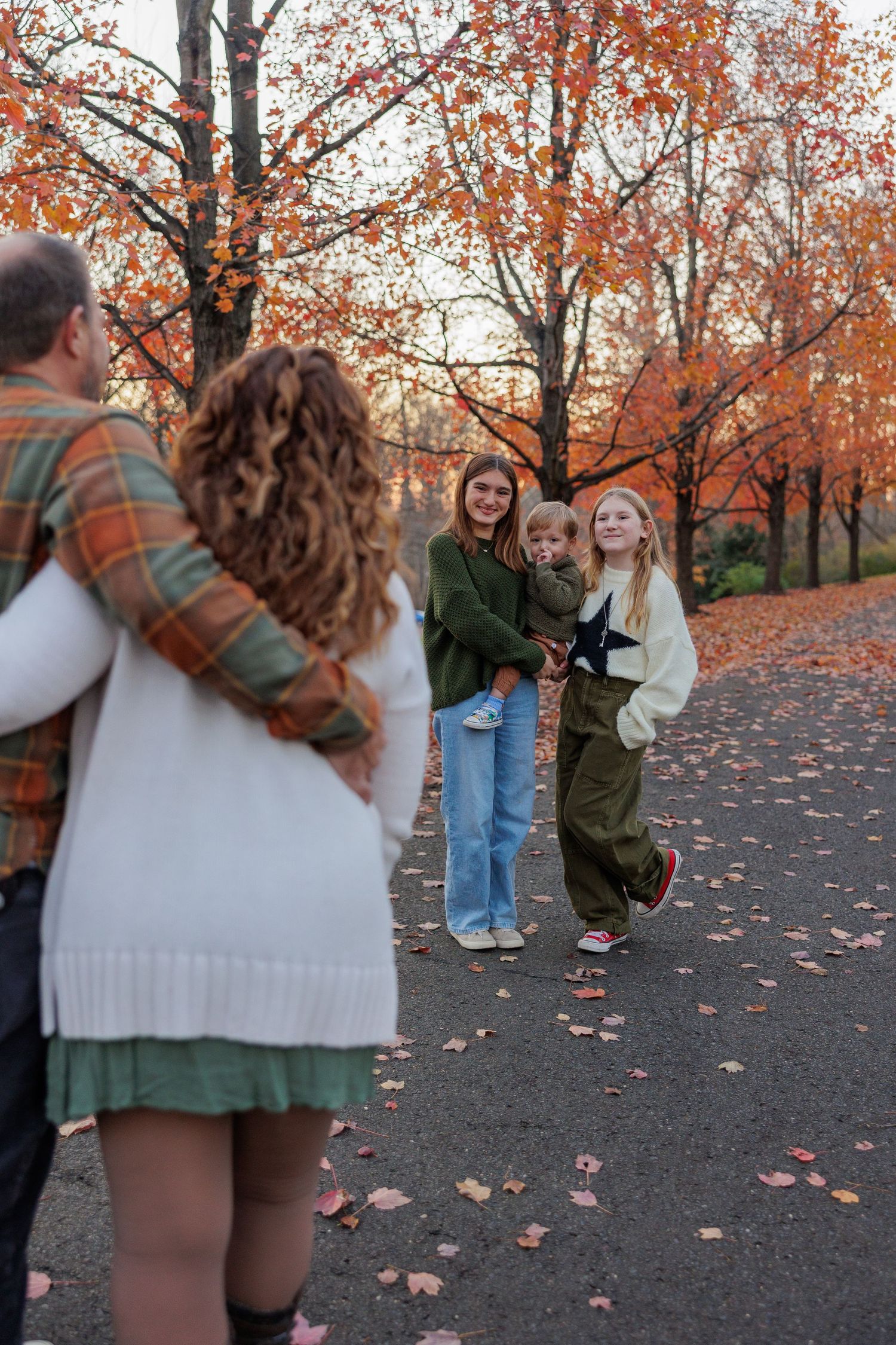 Siblings looking at parents smiling during family photo session at Smithville Park, Burlington County, New Jersey, by Rego Photography