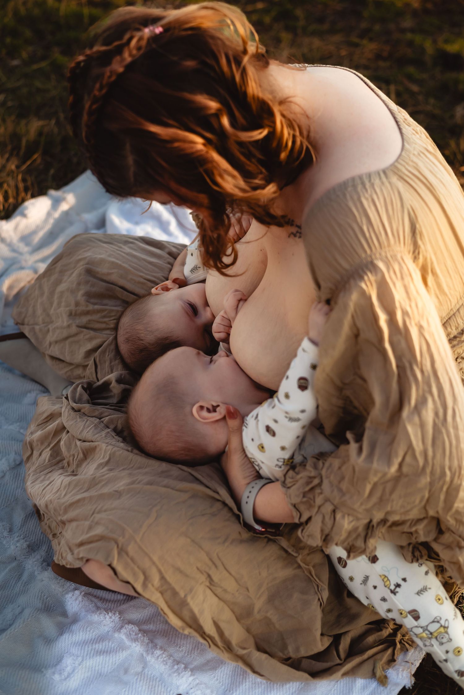 Sweet bonding moment between mother and baby on soft neutral bedding.