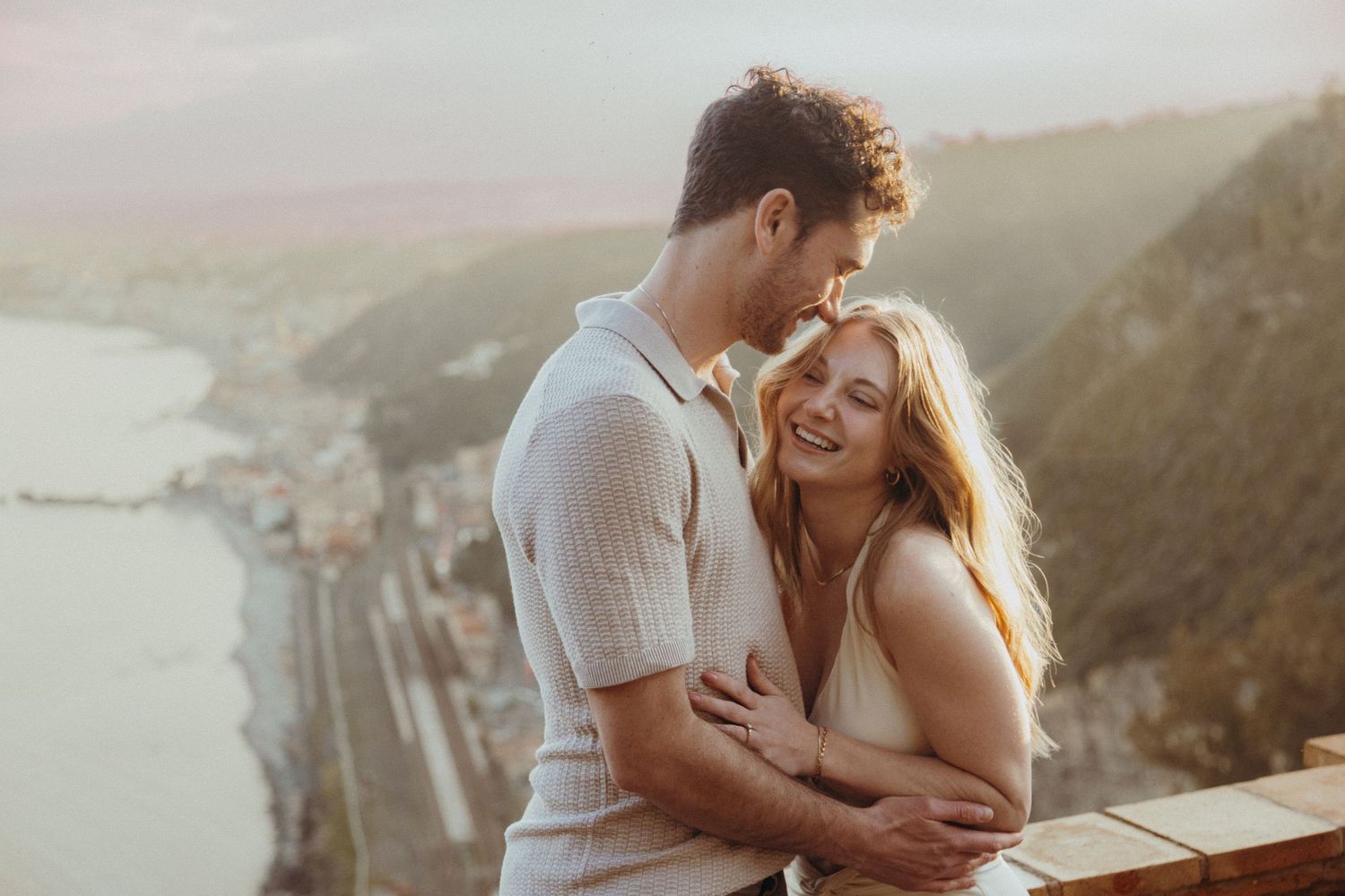 Candid moment of a couple laughing during their engagement shoot in Sicily