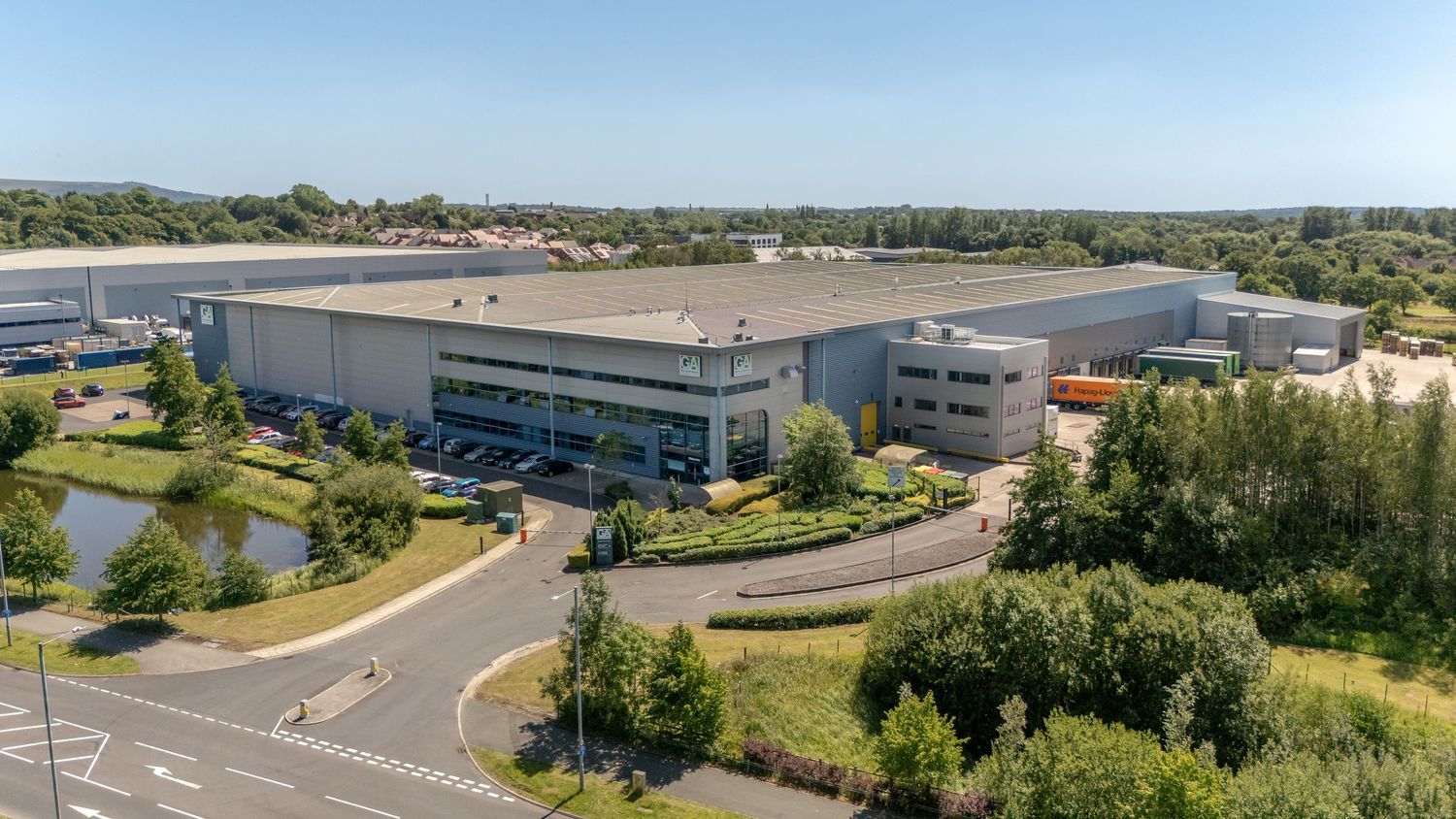 Drone photography and video of commercial buildings for marketing and website. Exterior Drone image of HQ warehouse on industrial park