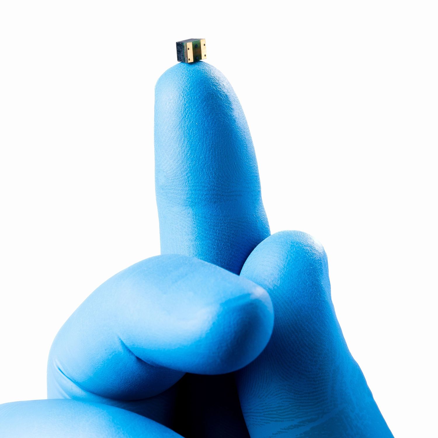 Commercial product photography of fuse on a gloved fingertip.