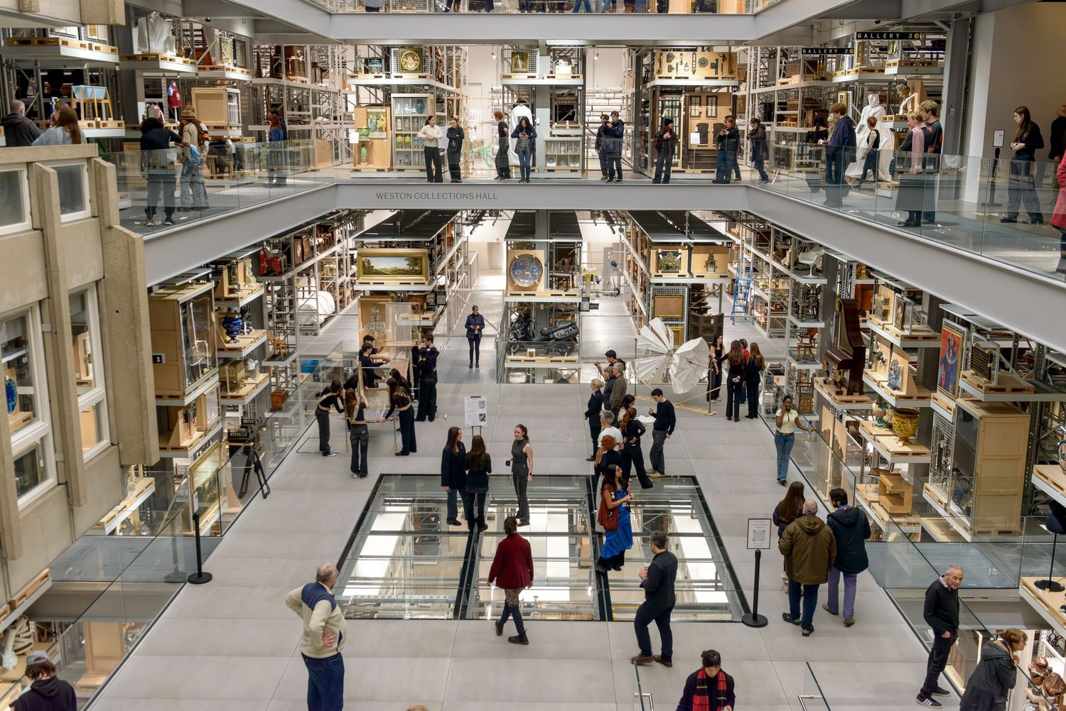 V&A East Storehouse, Interior of central open gallery surrounded with shelves of collection objects with people on the various floors .