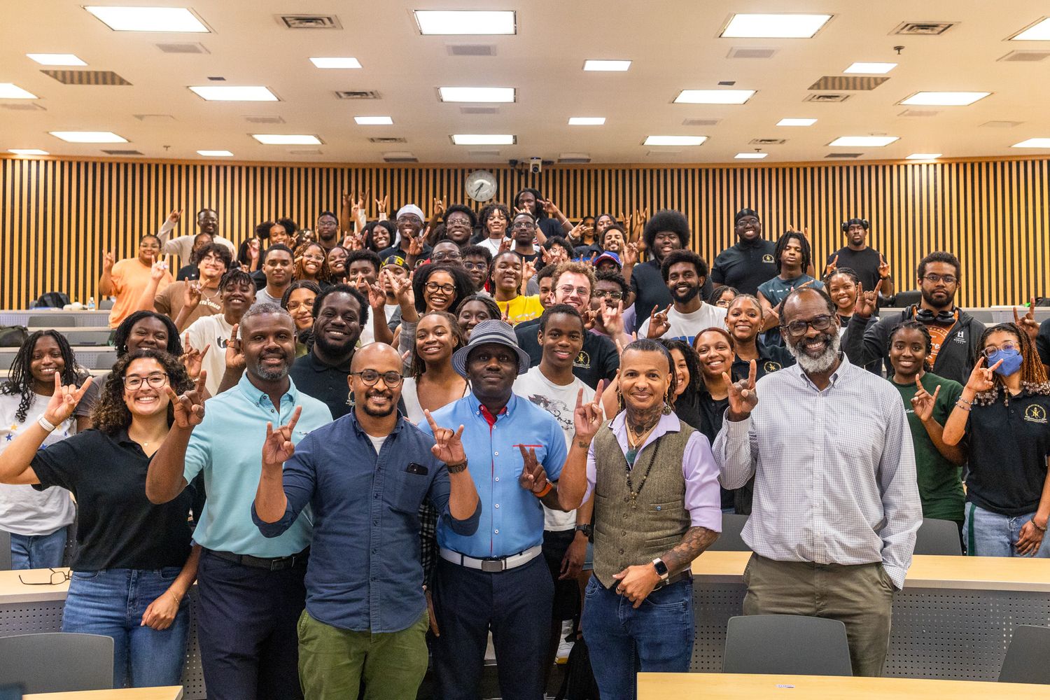 Large group of enthusiastic attendees pose together at a conference or meeting.