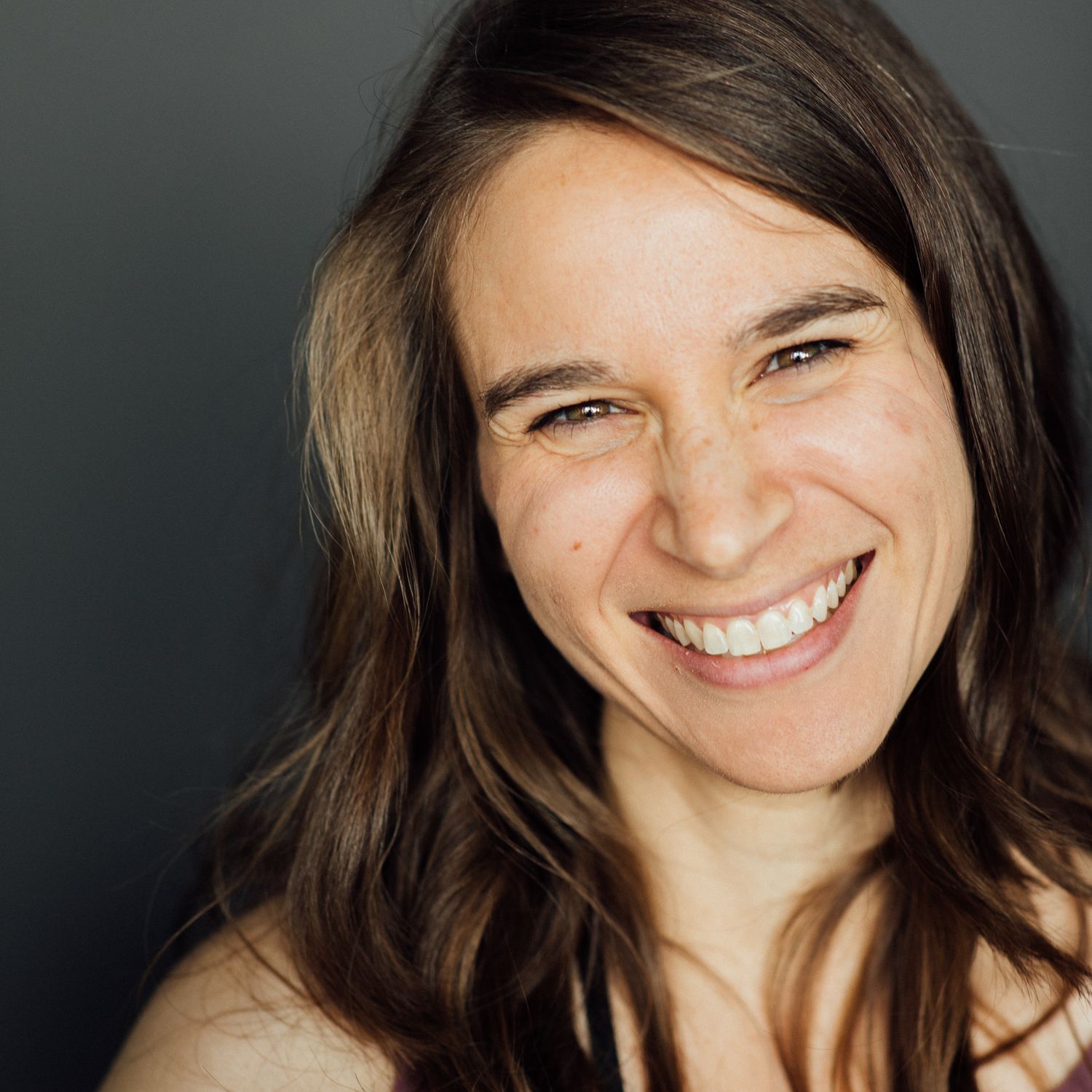 A photograph of a woman, Jessica Rix, smiling. Photo by Mike Malament.