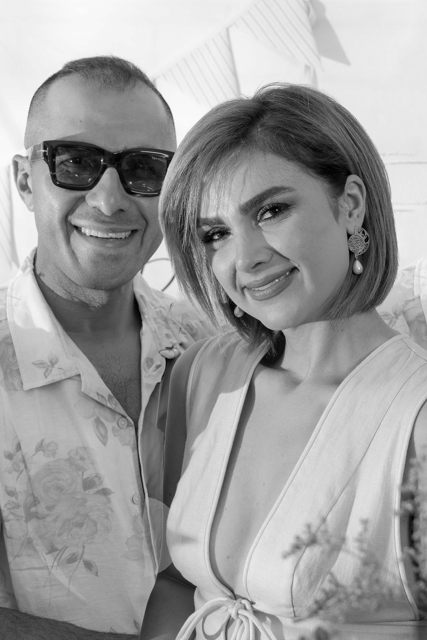 Black and white portrait of people smiling together in casual summer outfits.