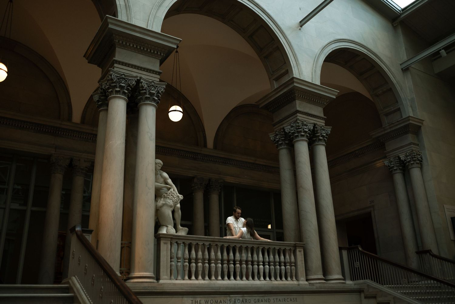 couple draped over railing at the Chicago art institute