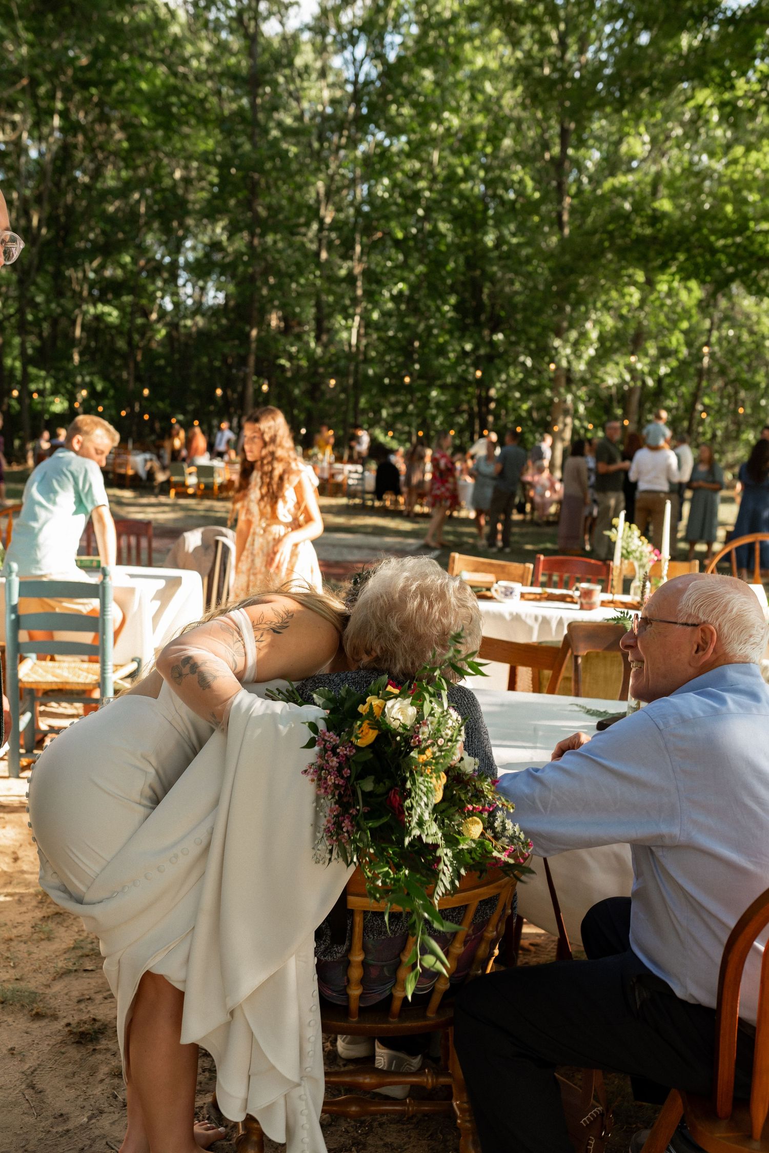 bride hugging grandparents after wedding ceremony