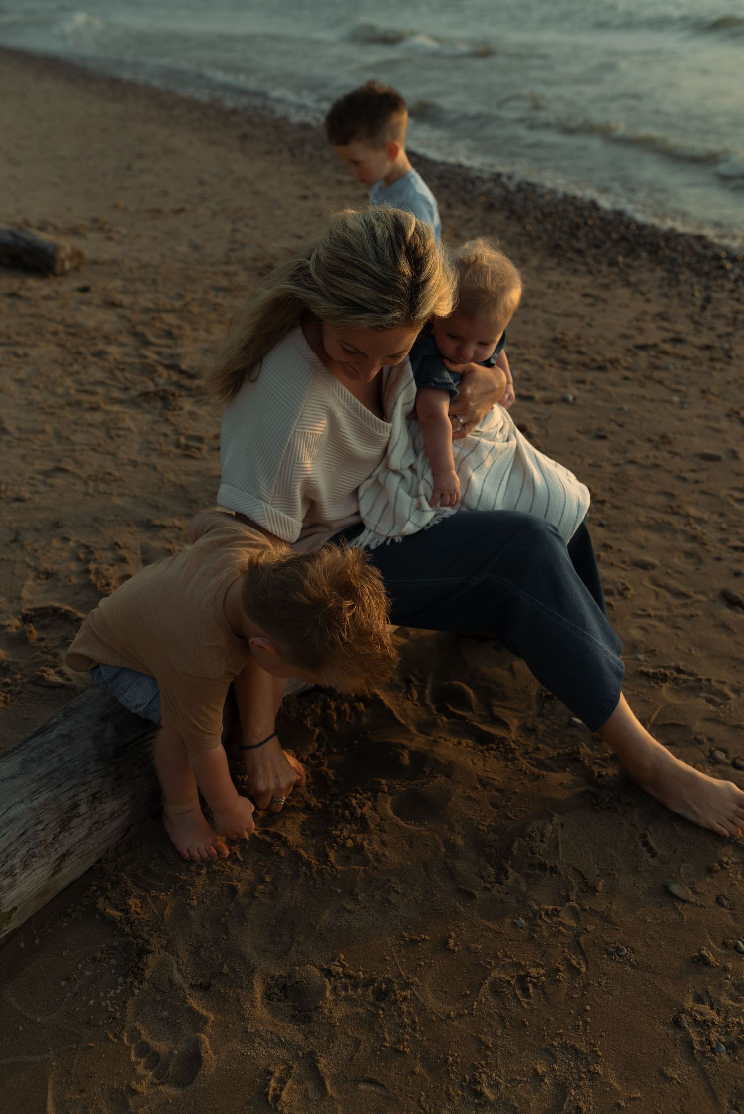 mom and her kids playing on the beach