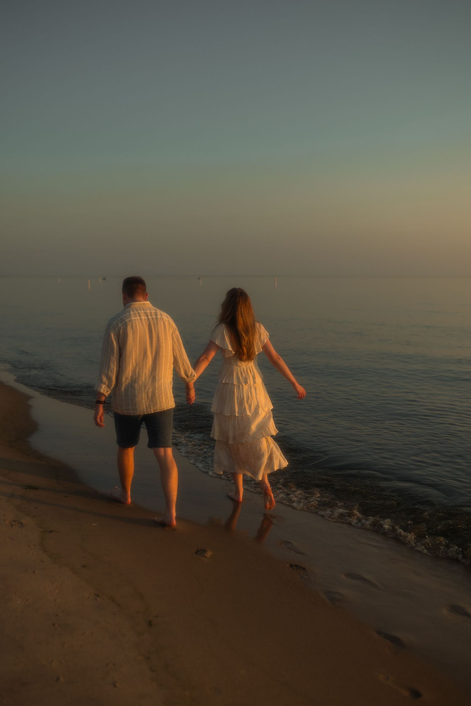 couple holding hands at the beach