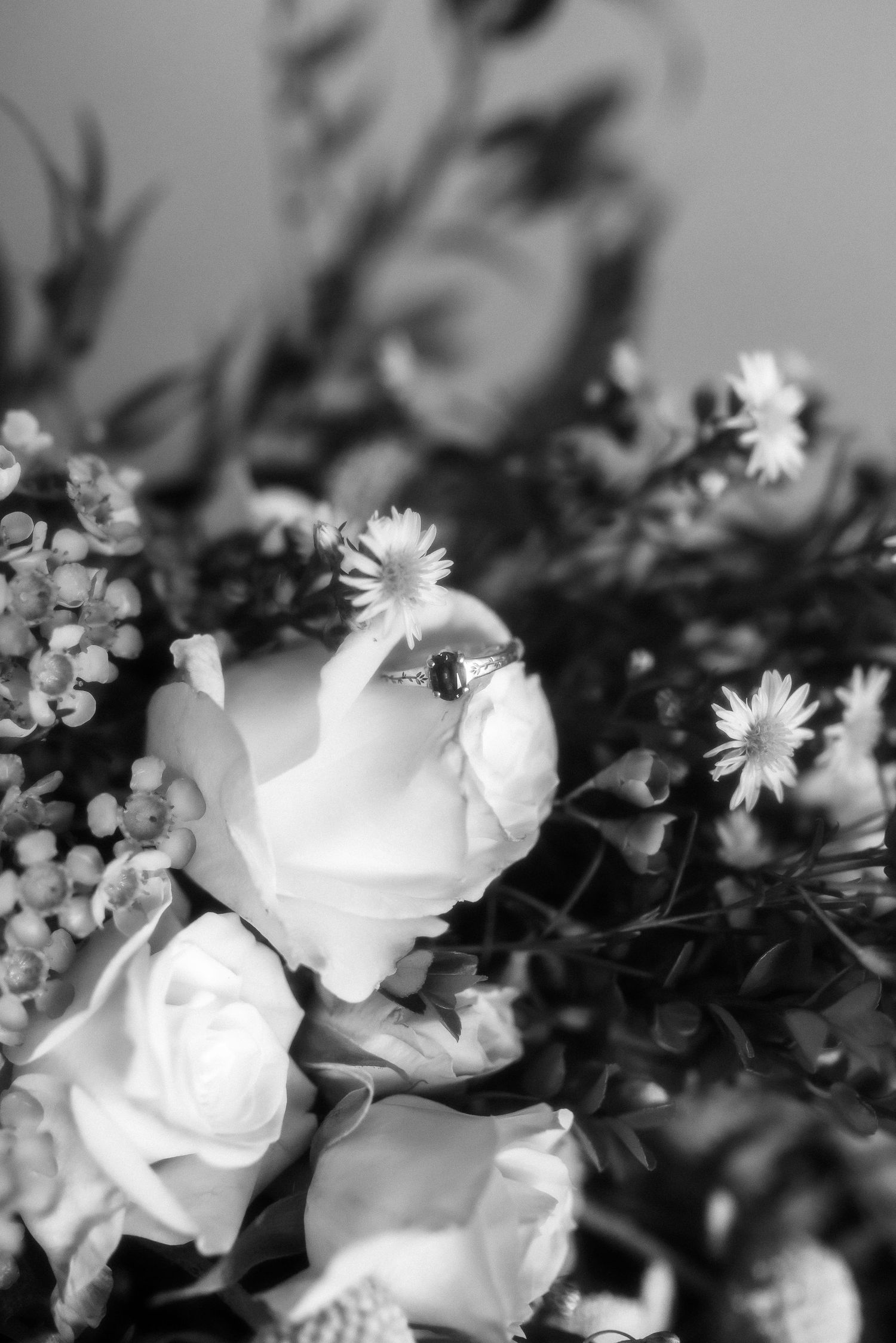 black and white shot of wedding ring in a bridal bouquet
