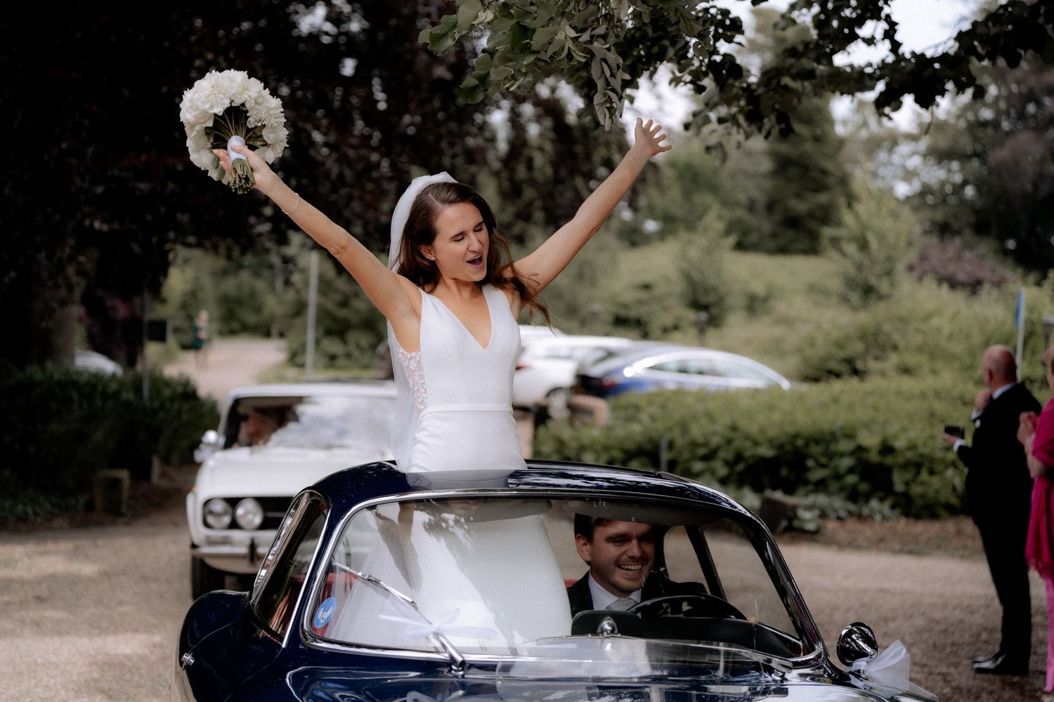 Bride in the car celebrating her wedding day