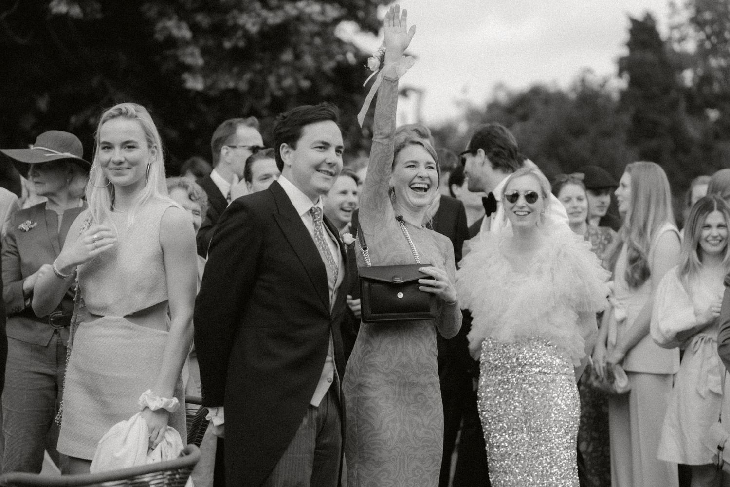 Guests at wedding and woman saluting the bride