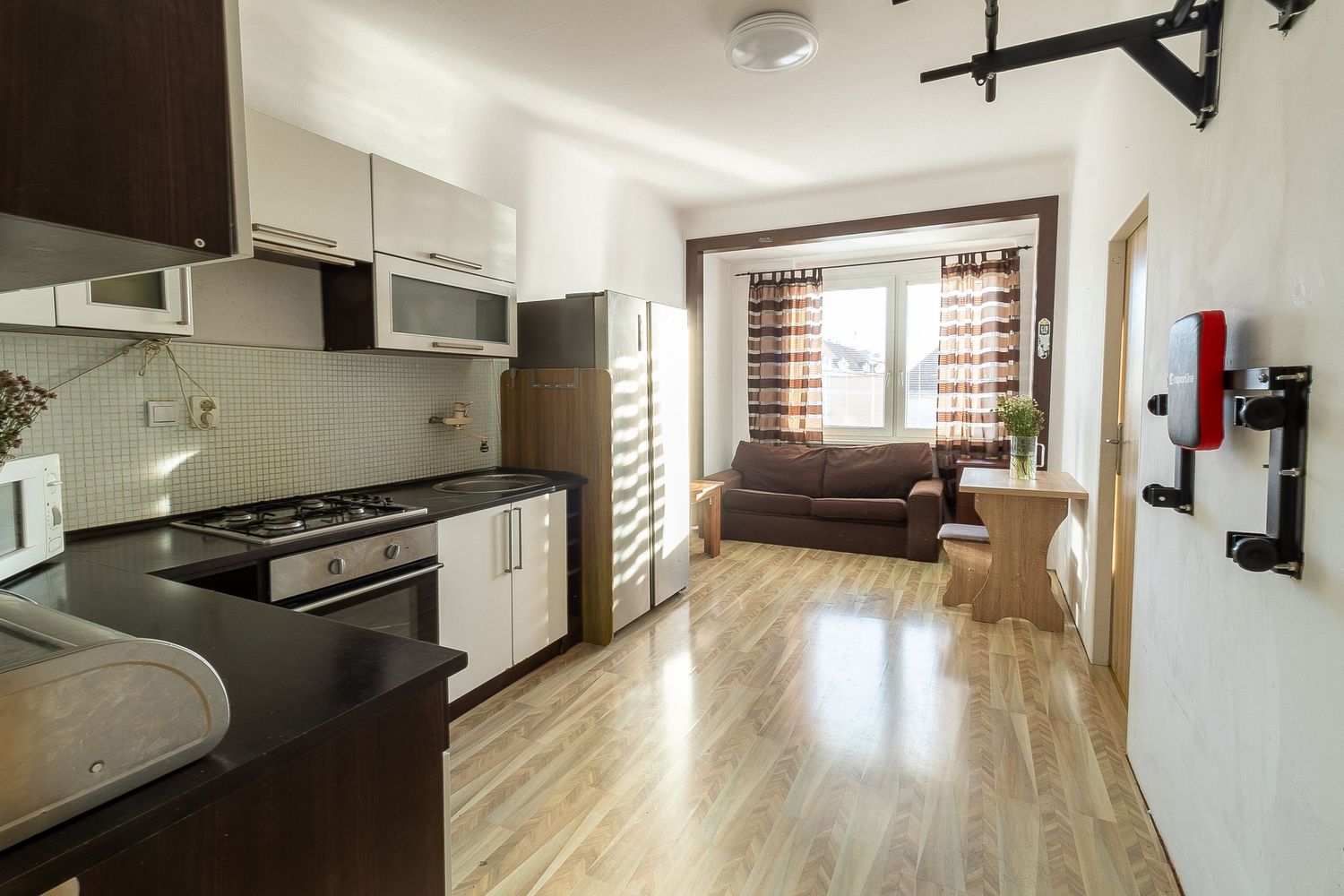 Open concept kitchen and living space with modern appliances and hardwood floors.