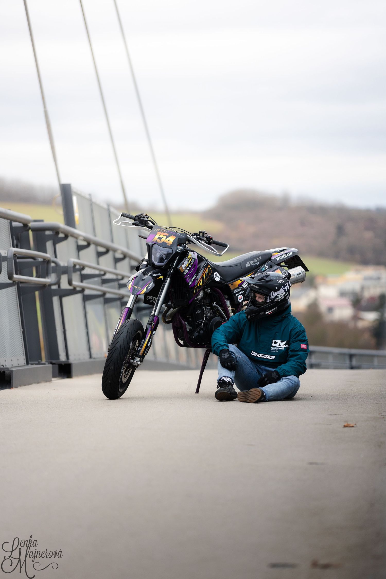 A sequence of images showing a person performing a dramatic motorcycle stunt on a concrete surface.