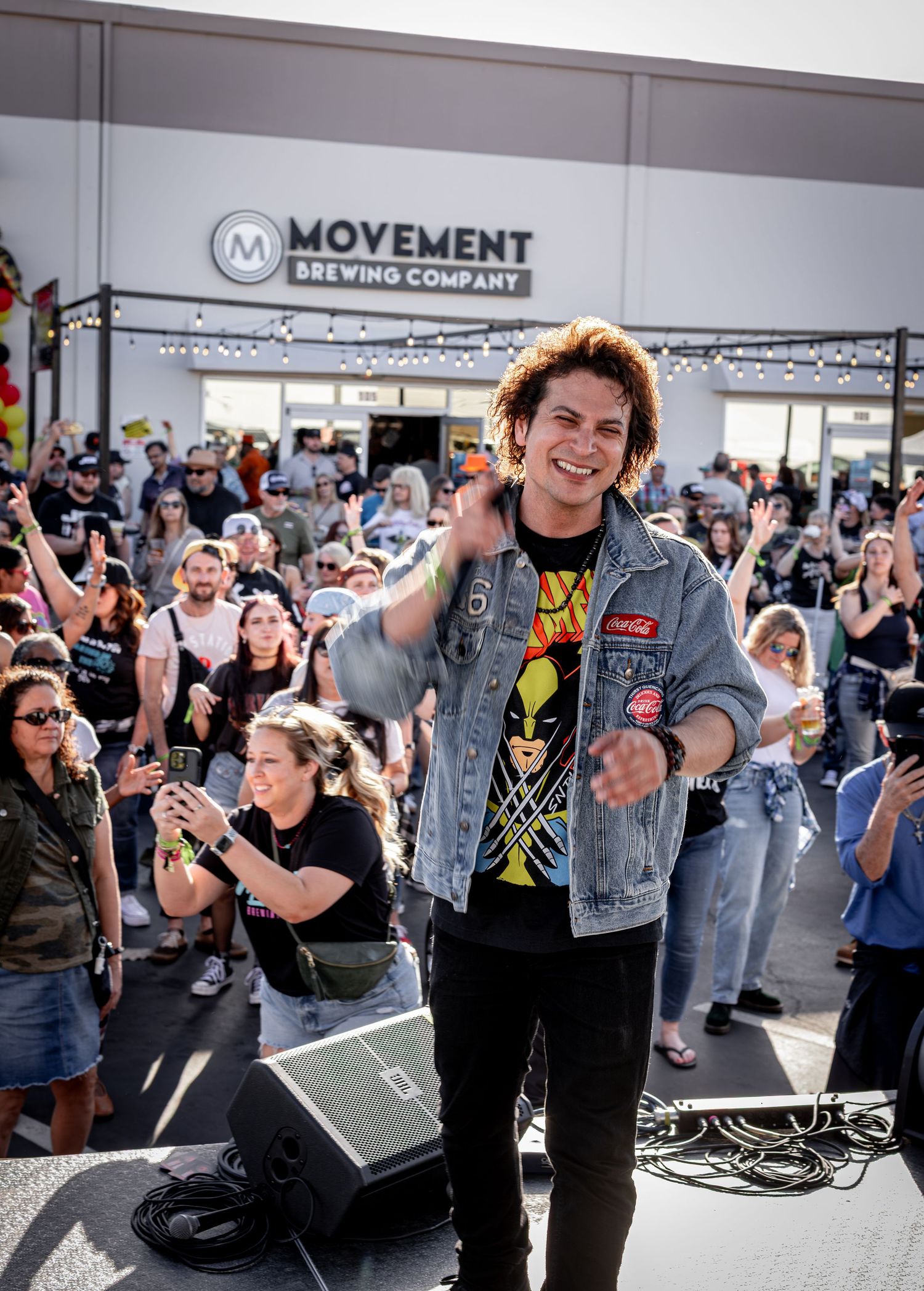 Energetic crowd enjoying live music performance at outdoor festival venue.