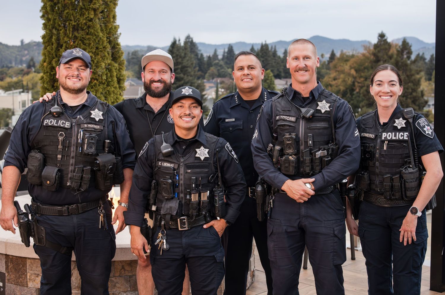 Group of uniformed police officers posing together for a department photo.