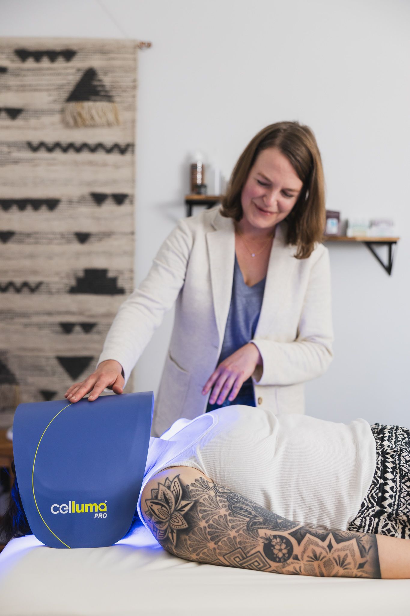 woman acupuncturist doing facial light therapy in client session on woman in treatment room in Maple Valley, WA for service branding photo