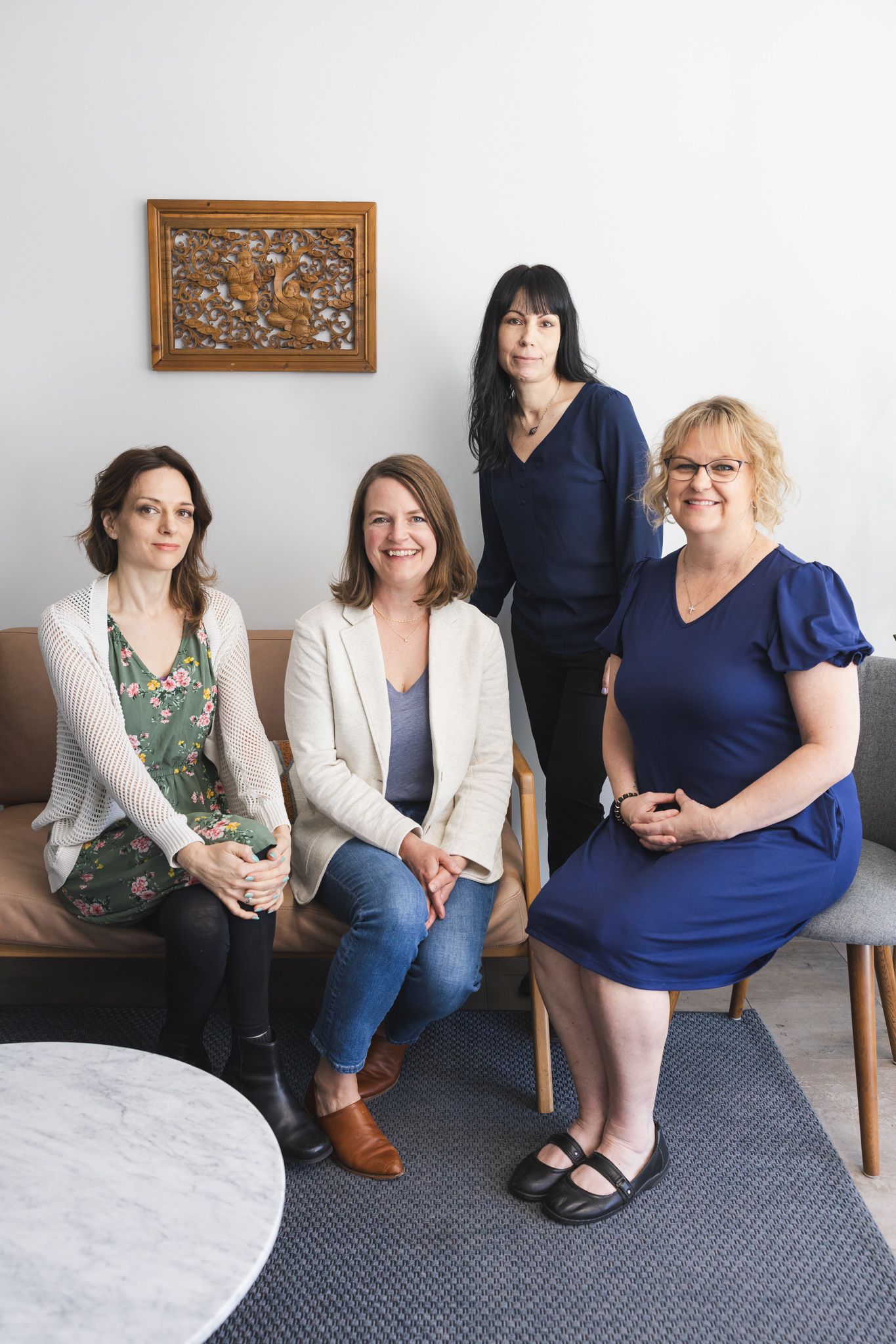 group of 4 women, 1 owner, 2 acupuncture practitioners and 1 front desk employee sitting for group team headshot in Maple Valley, WA