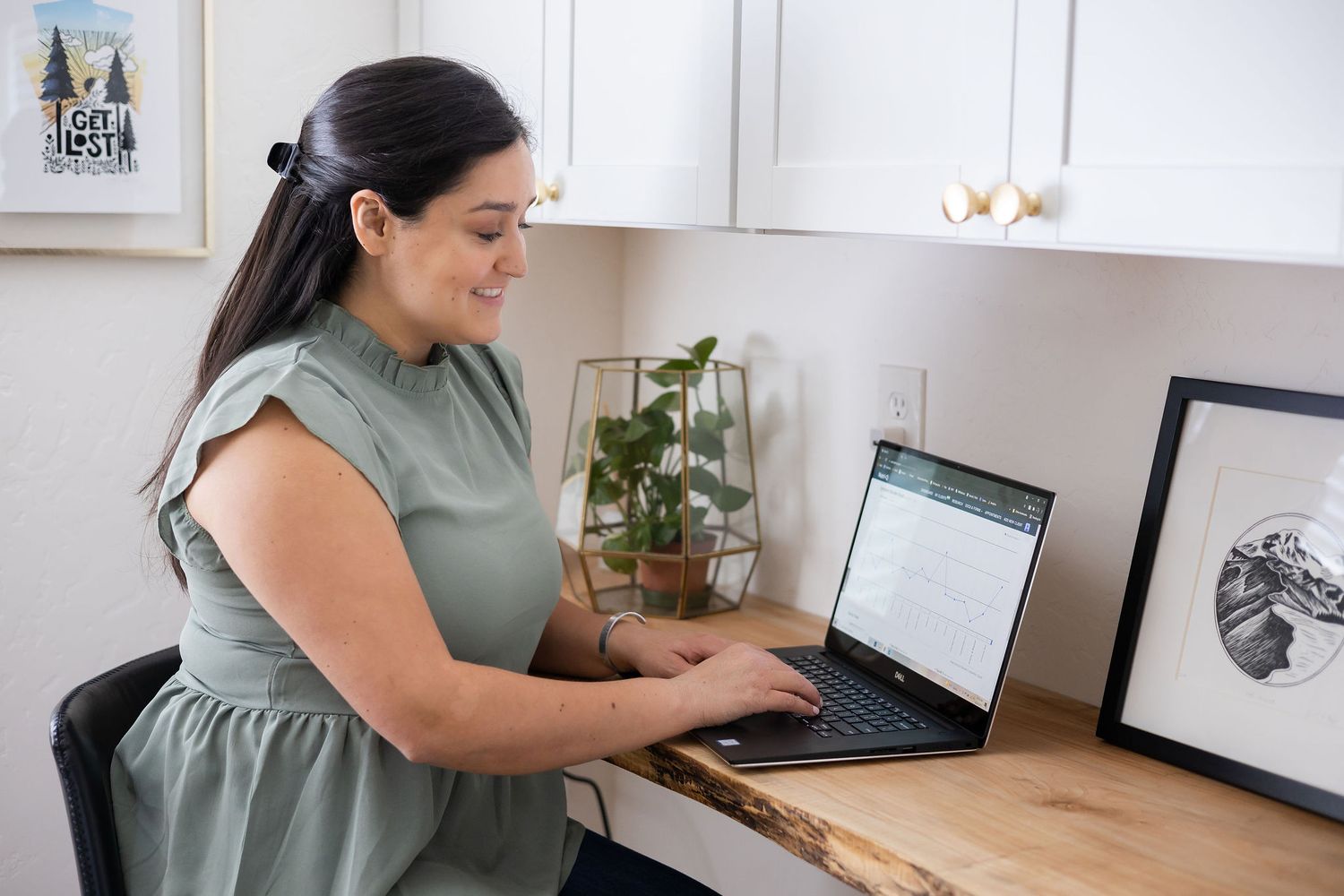 woman nutritionist sitting at computer looking over client chart at desk brand lifestyle photo in Seattle, WA