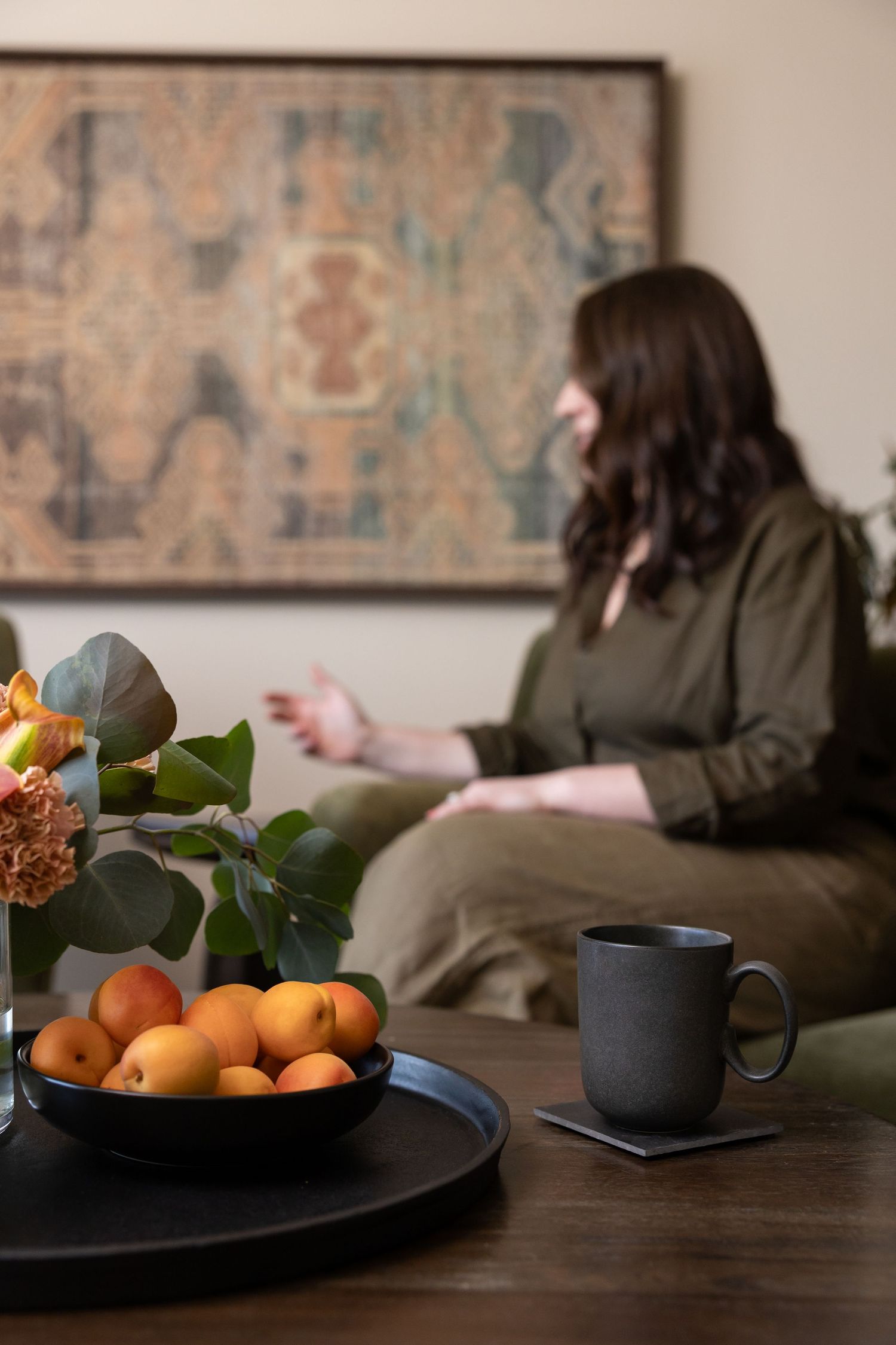 woman mental health therapist sitting in treatment room talking to client during session in Tacoma, WA room woman owned business