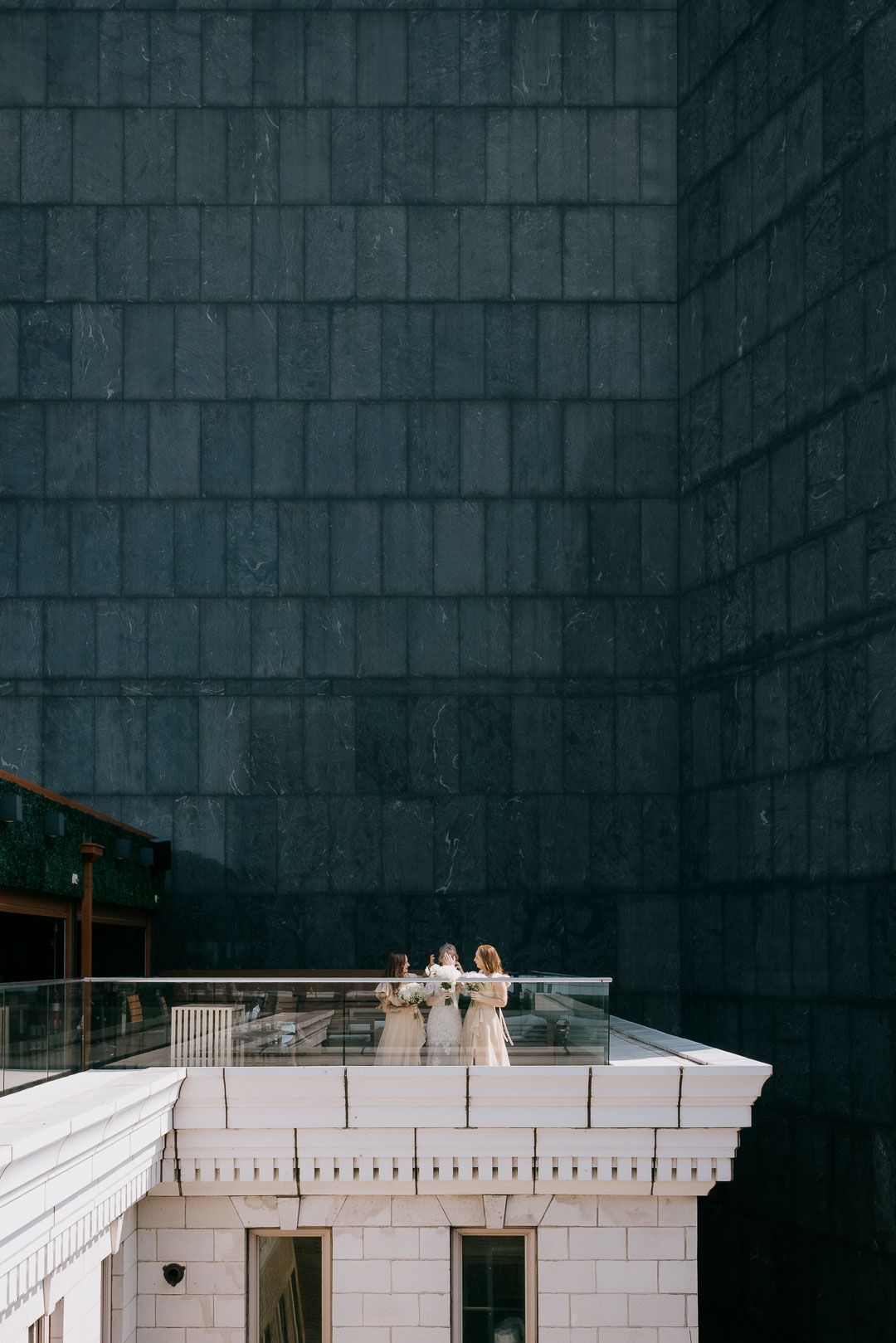 Rooftop wedding portrait of bride with bridesmaids overlooking Cleveland skyline by Ohio wedding photographer.