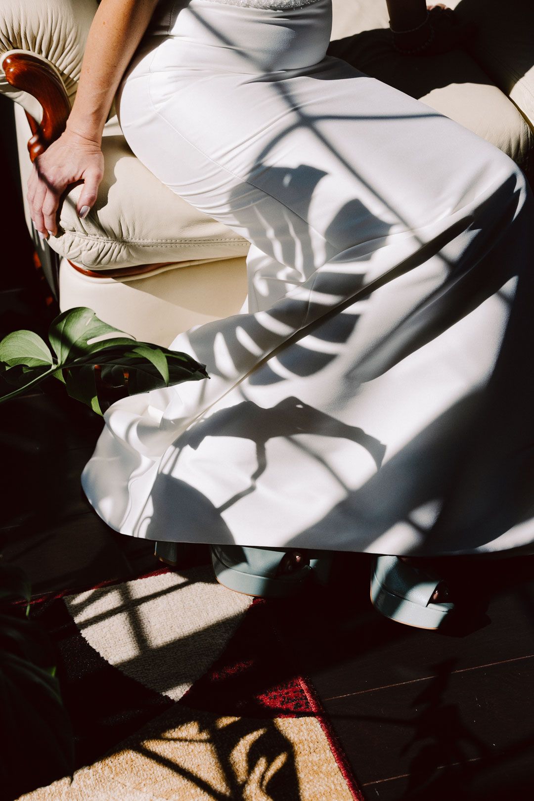 Artful bridal detail with sunlight and shadows of foliage on modern wedding dress, shot by a Cleveland Ohio wedding photographer.