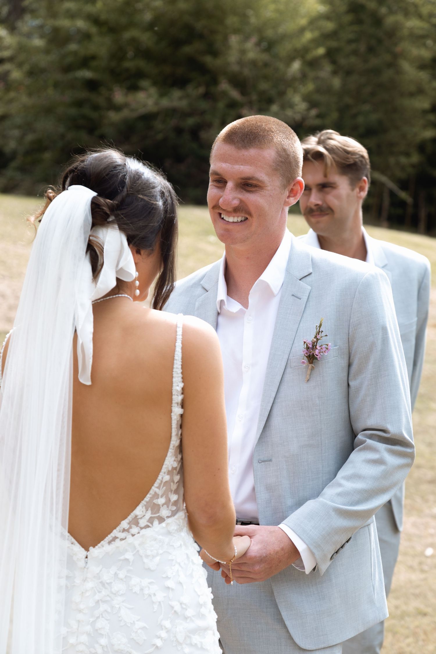 A sequence of romantic wedding photos showing a bride and groom in a light gray suit embracing outdoors.