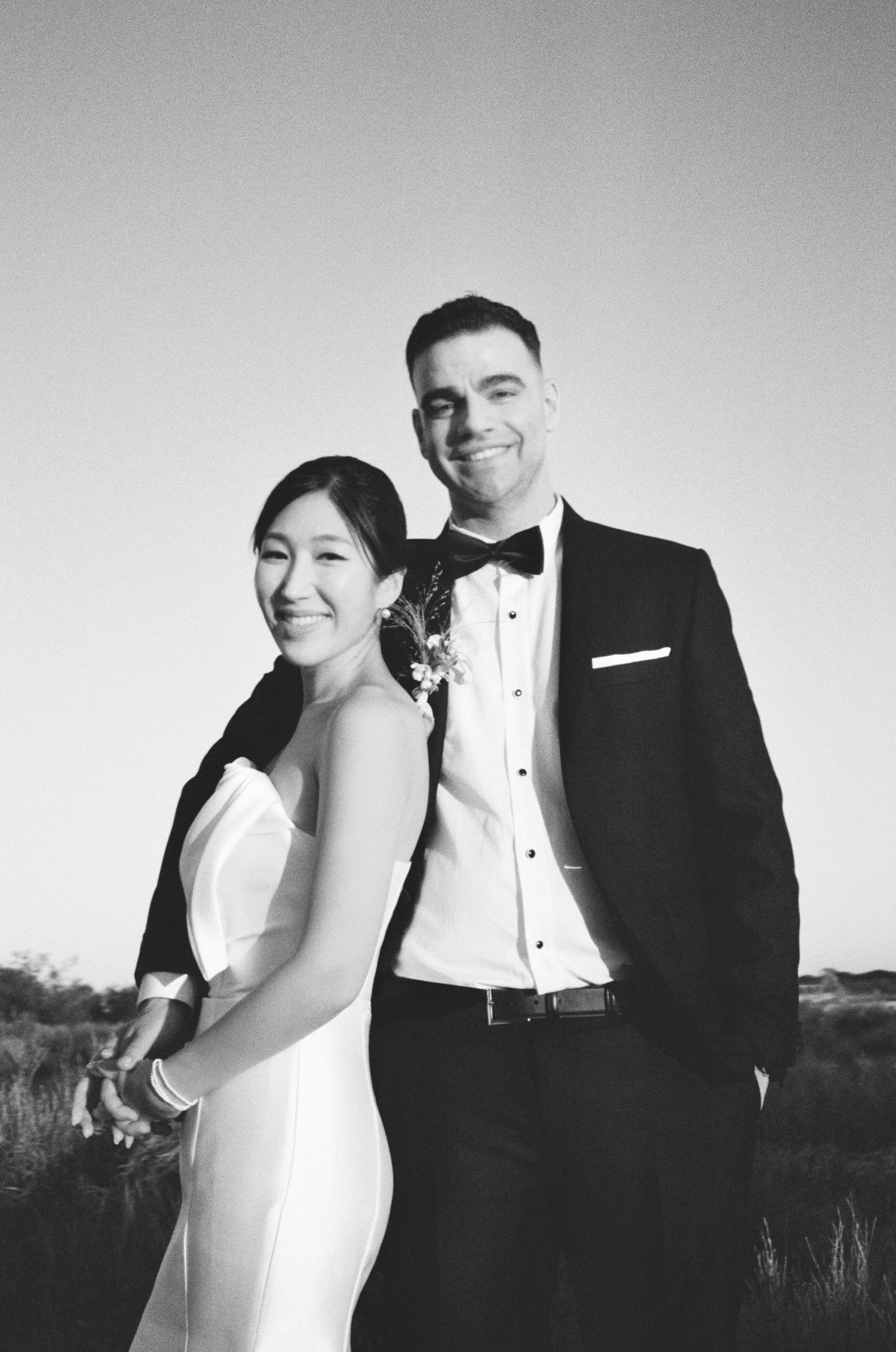 Black and white wedding photos show a couple in formal attire posing together against outdoor backgrounds.
