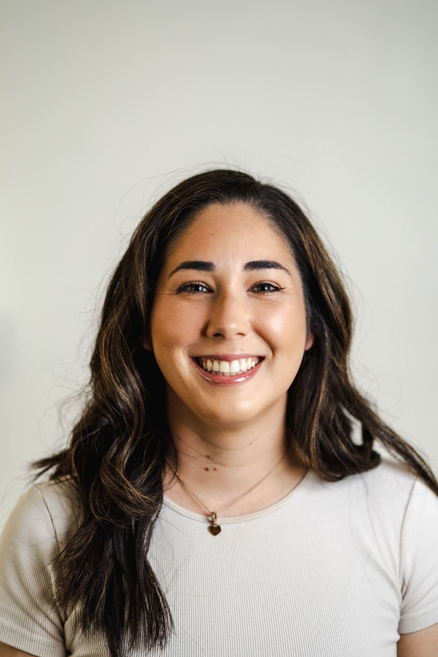 Professional headshot portrait against a light gray background.