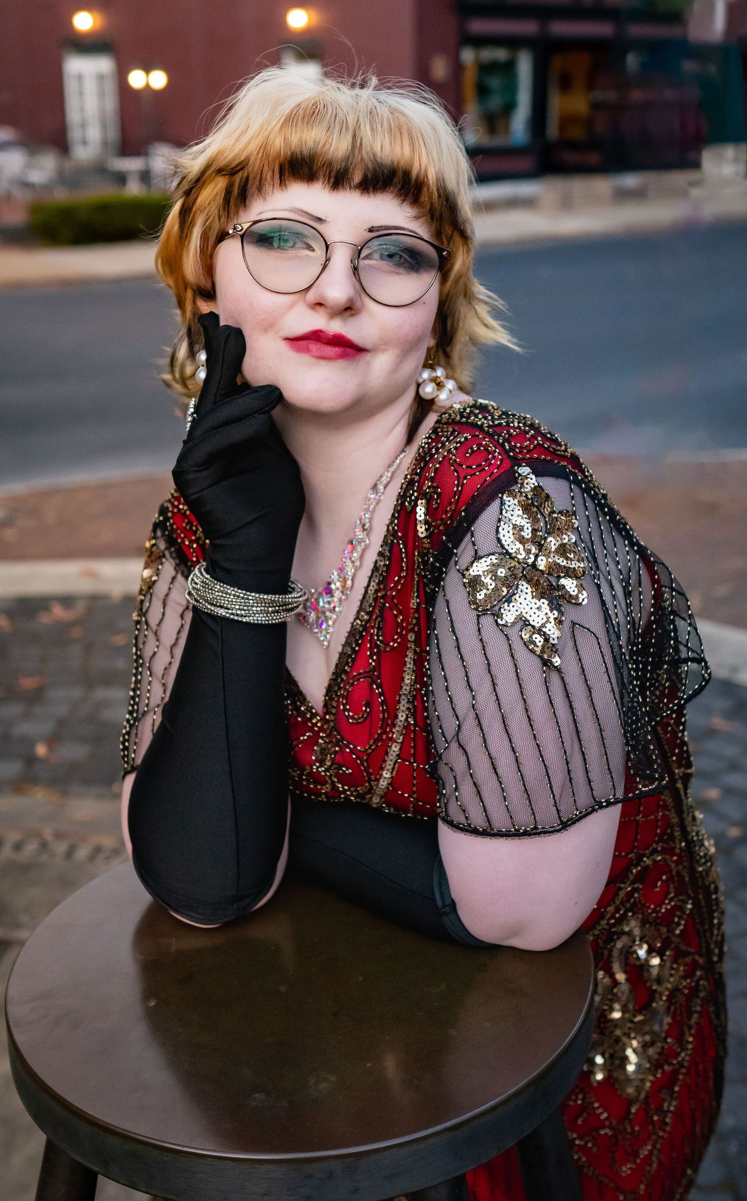 A senior portrait featuring a young woman dressed like a classy 1920's style flapper near the train station in Staunton, Virginia.