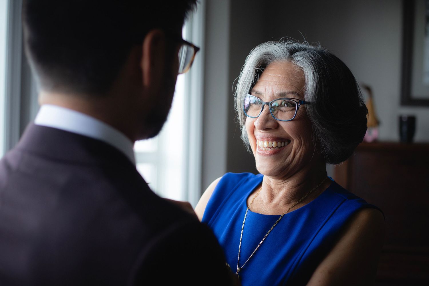 Warm conversation between two people by a window with natural light.