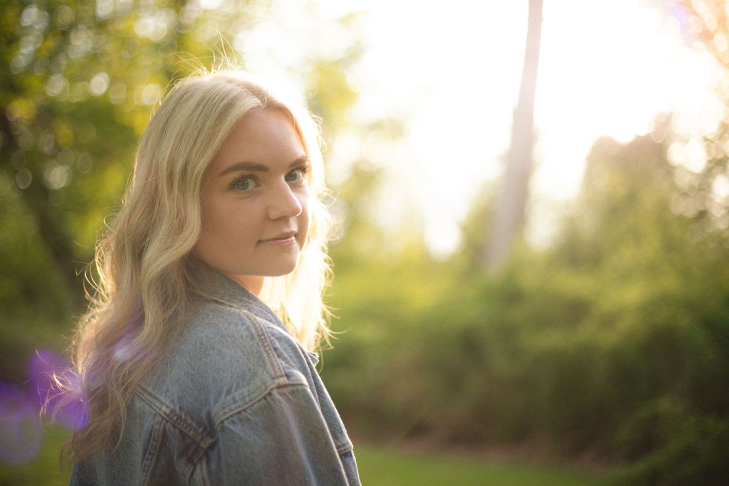 Soft natural lighting illuminates a profile against blurred green foliage.